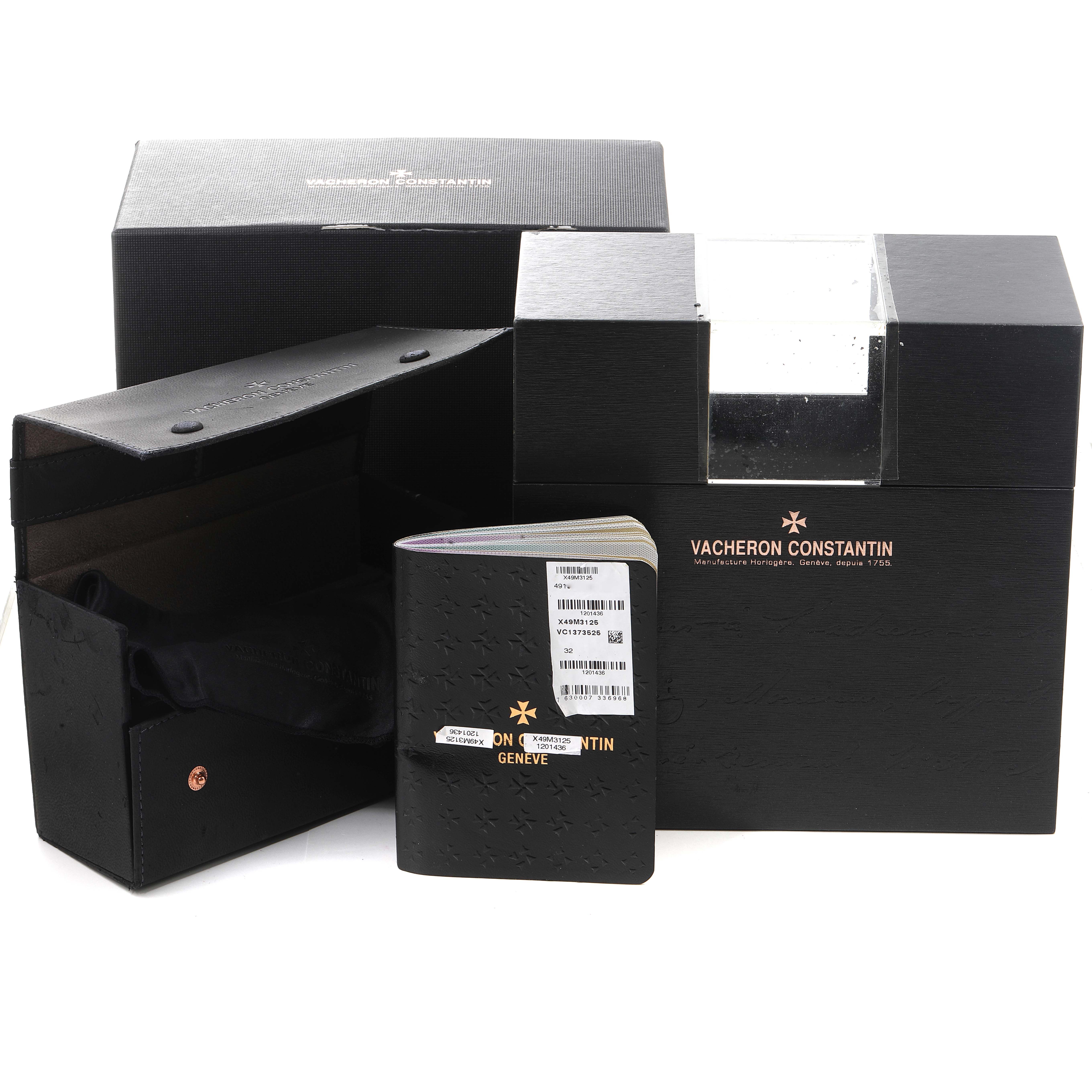 The image shows the packaging and documentation for the Vacheron Constantin Overseas 49150/000M-9338 Men's Steel and Gold (two tone) Grey Dial 49150/000M-9338 Men's Steel and Gold (two tone) Grey Dial watch, including boxes and manuals.