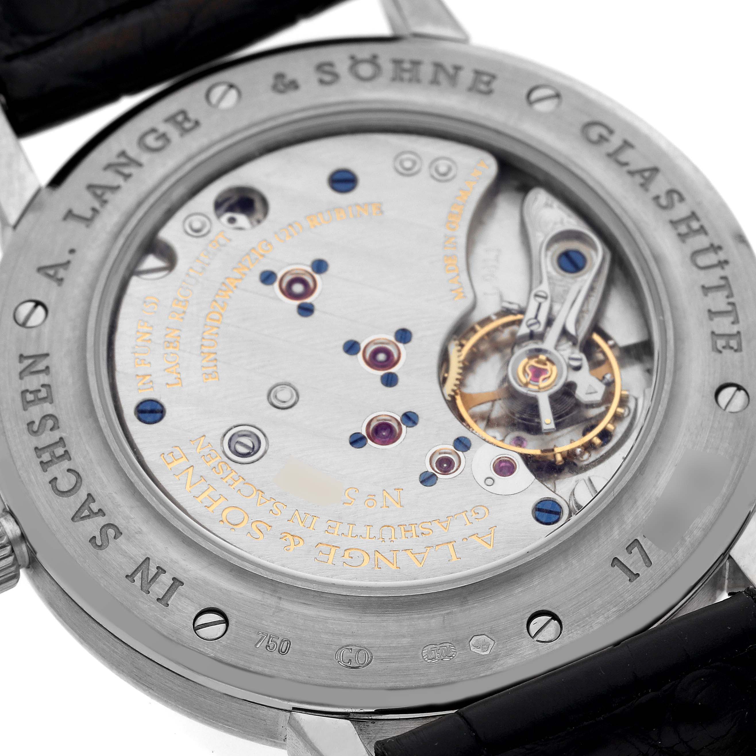 The image shows the back view of the A. Lange & Sohne Saxonia 215.029 Men's White Gold Black Dial, highlighting its movement and engravings.