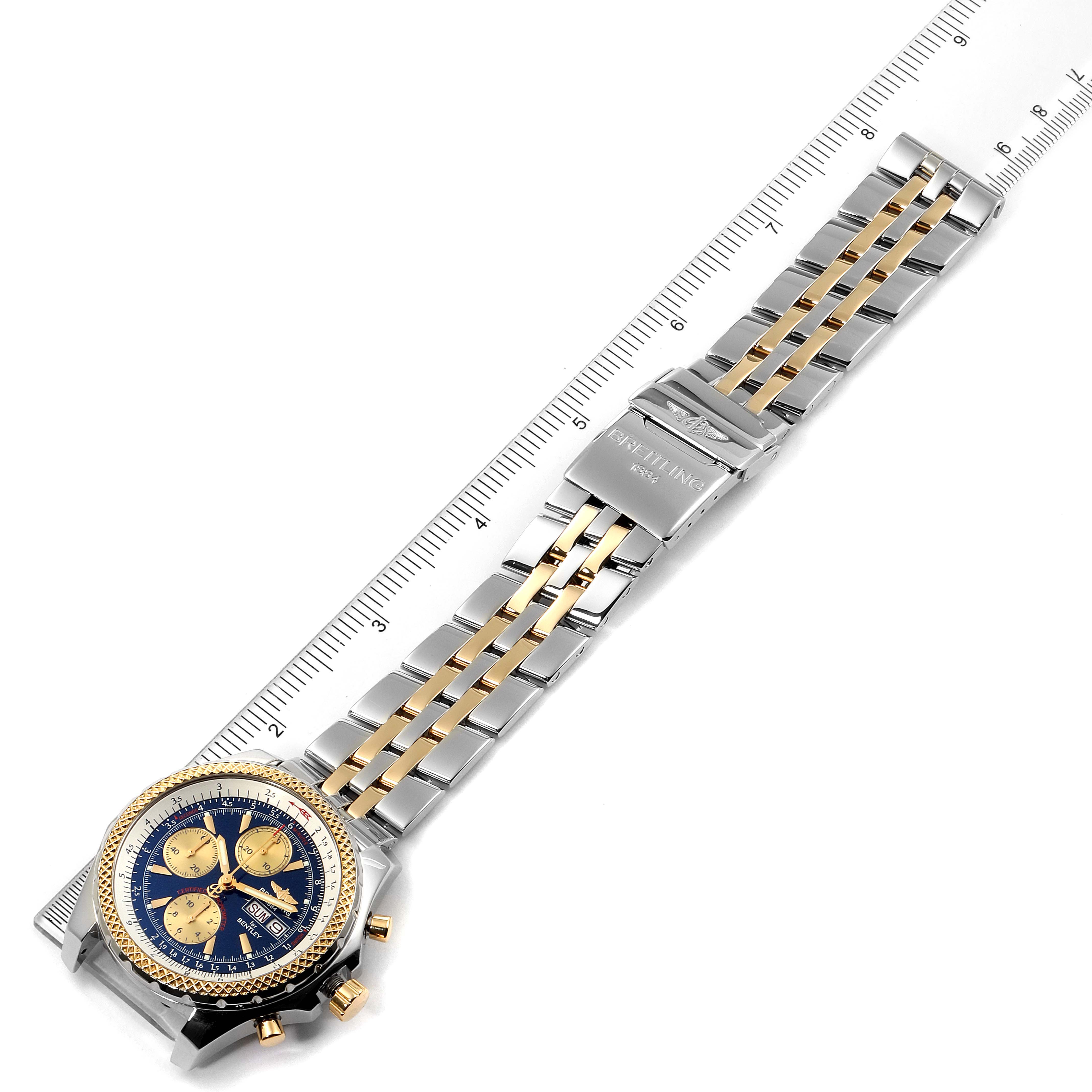 The image shows a Bentley model by Breitling, displayed flat, highlighting its two-tone bracelet, clasp, and face next to a ruler.