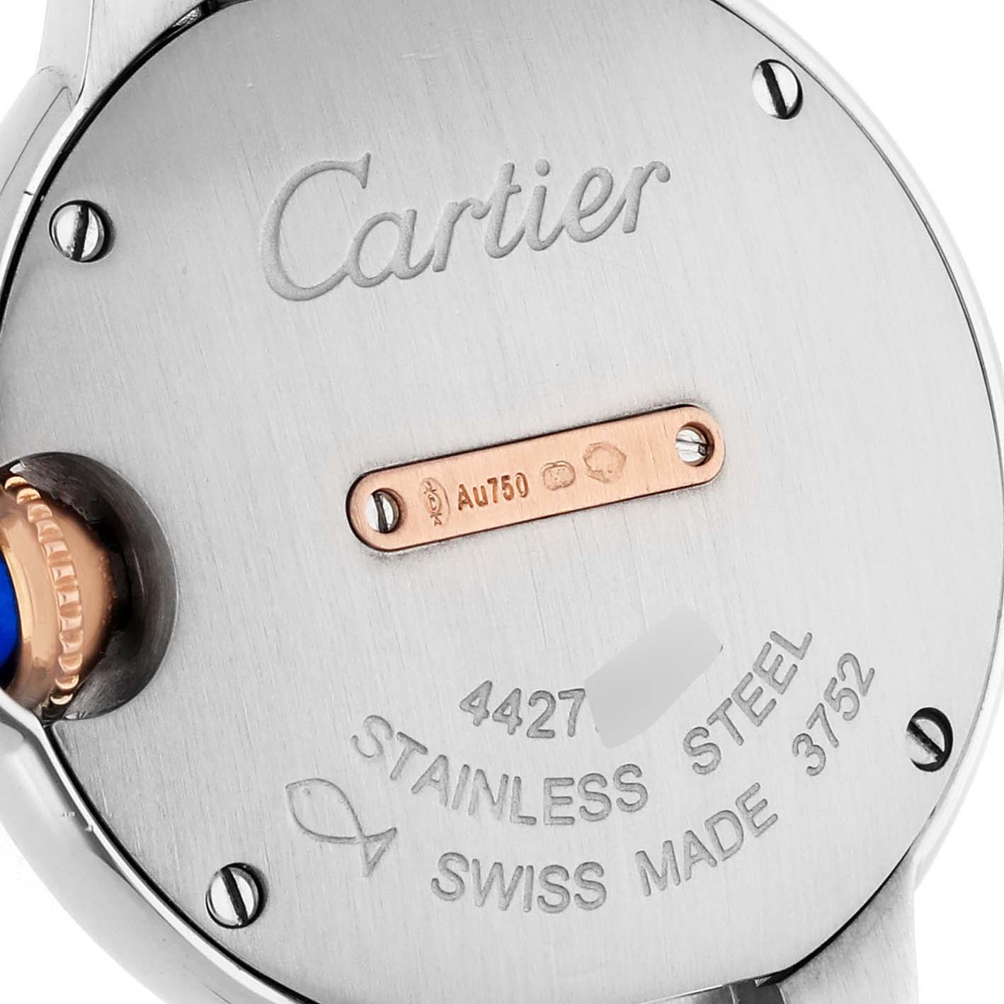 The image shows the back case of a Cartier Ballon Bleu W3BB0005 Women's Steel and Gold (two tone) Silver Dial watch with engraved details and a side view of the crown.