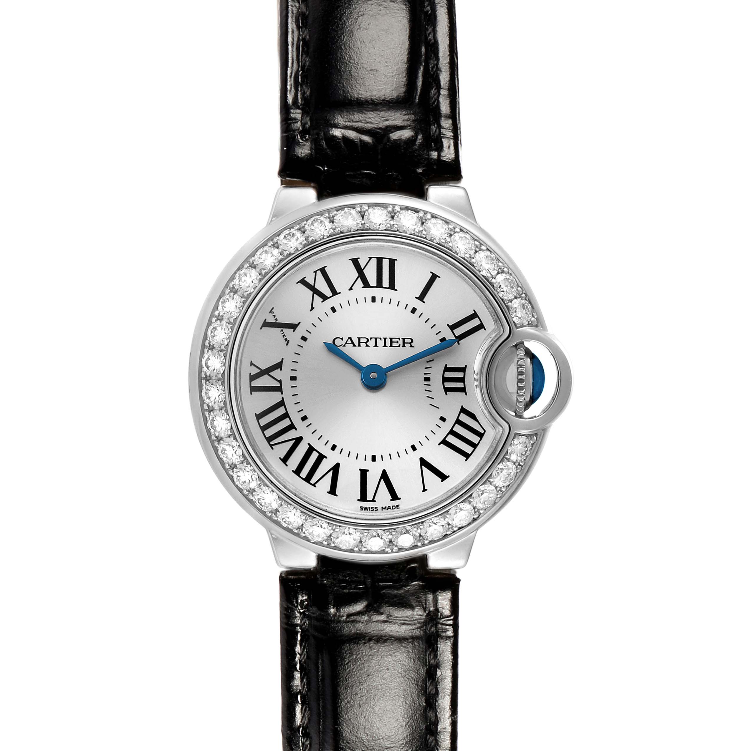 The Cartier Ballon Bleu WE900351 Women's White Gold Silver Dial watch is shown from a front angle, featuring its round face, Roman numerals, diamond bezel, and leather strap.