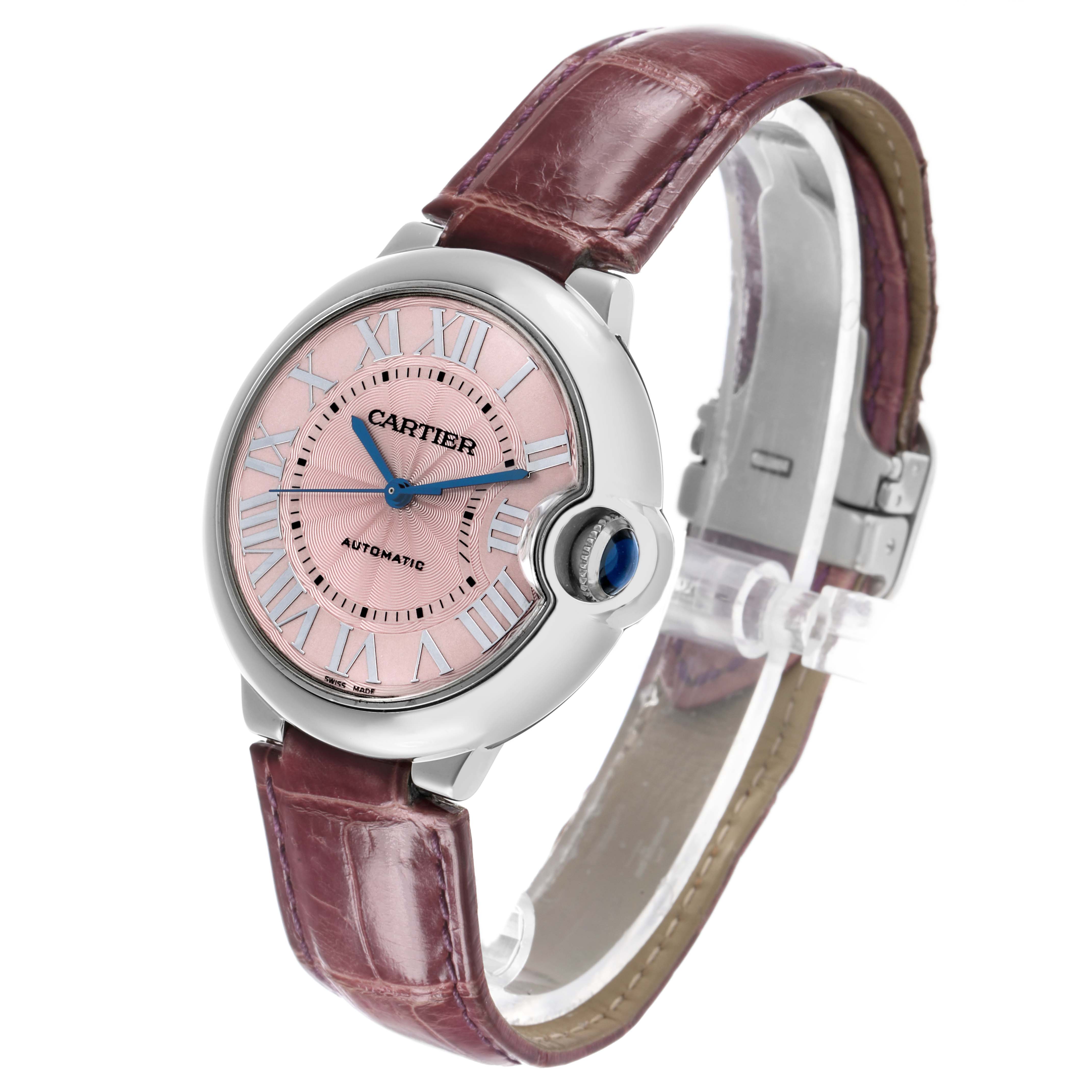 The Cartier Ballon Bleu WSBB0007 Women's Stainless Steel Pink Dial watch is shown at a three-quarter angle, highlighting the face, crown, and leather strap.