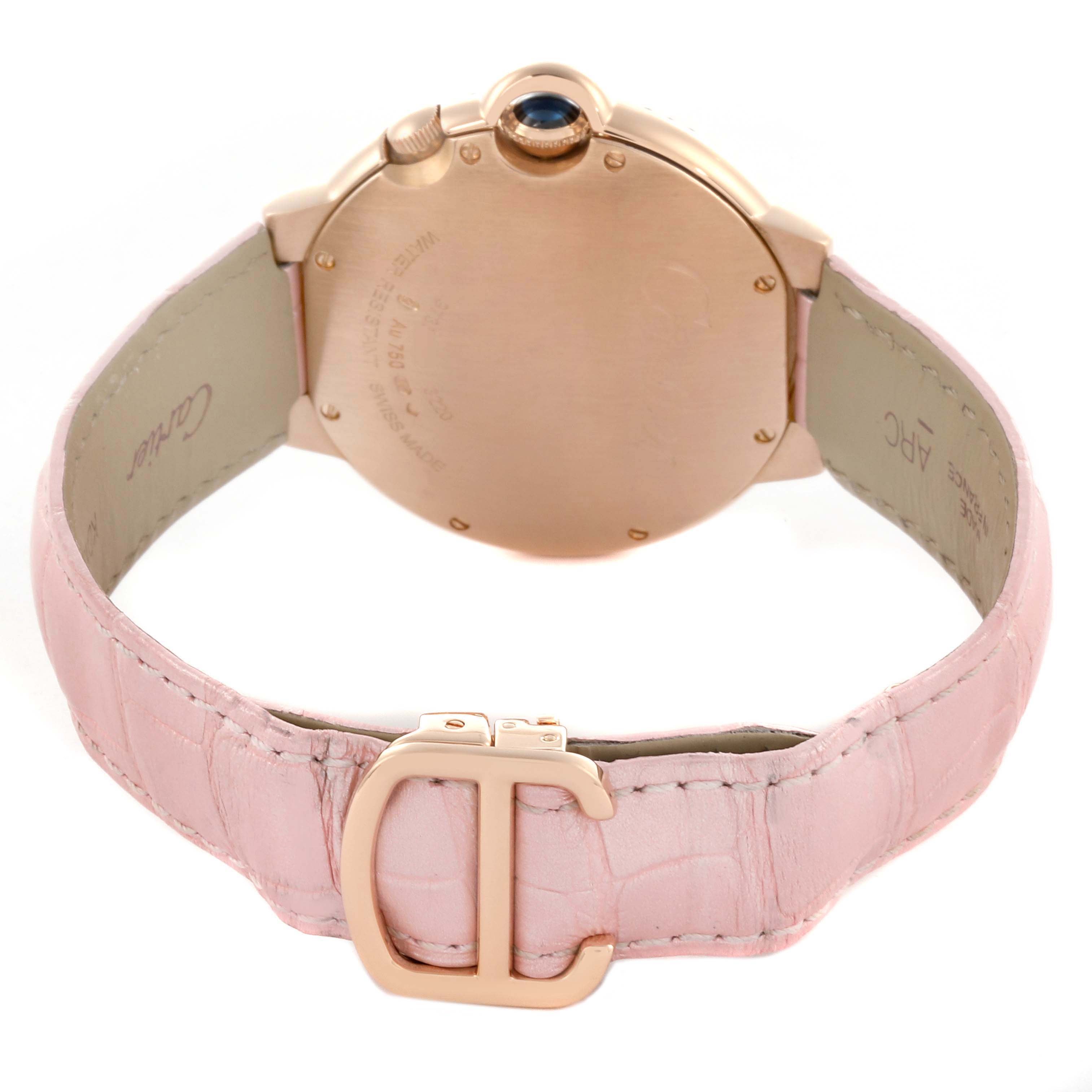 The Cartier Ballon Bleu WE902018 Women's Rose Gold Mother of Pearl Dial watch is shown from the back, highlighting the clasp, case, and pink leather strap.