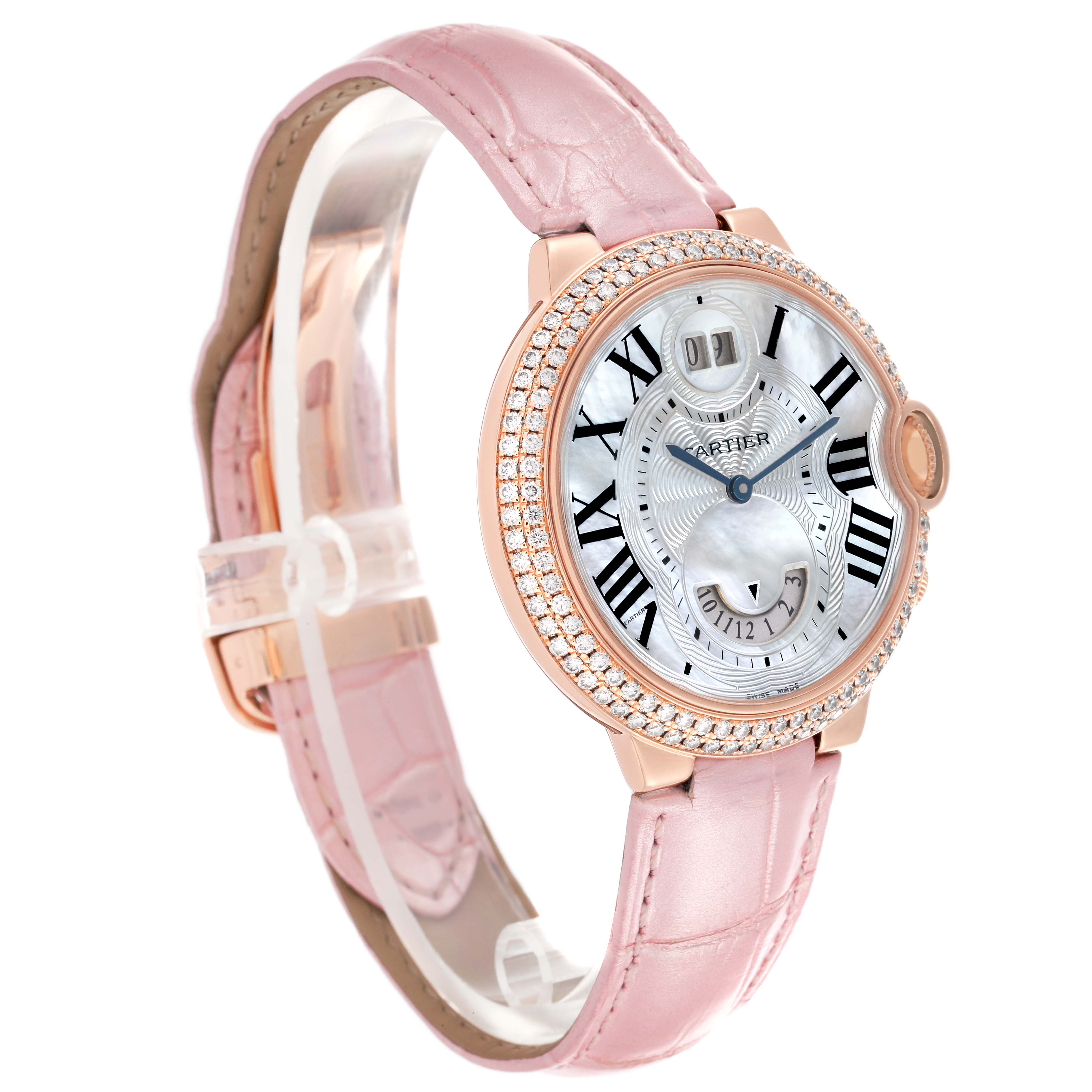 The Cartier Ballon Bleu WE902018 Women's Rose Gold Mother of Pearl Dial watch is shown at a slight angle, highlighting the pink strap, jeweled bezel, and detailed face.
