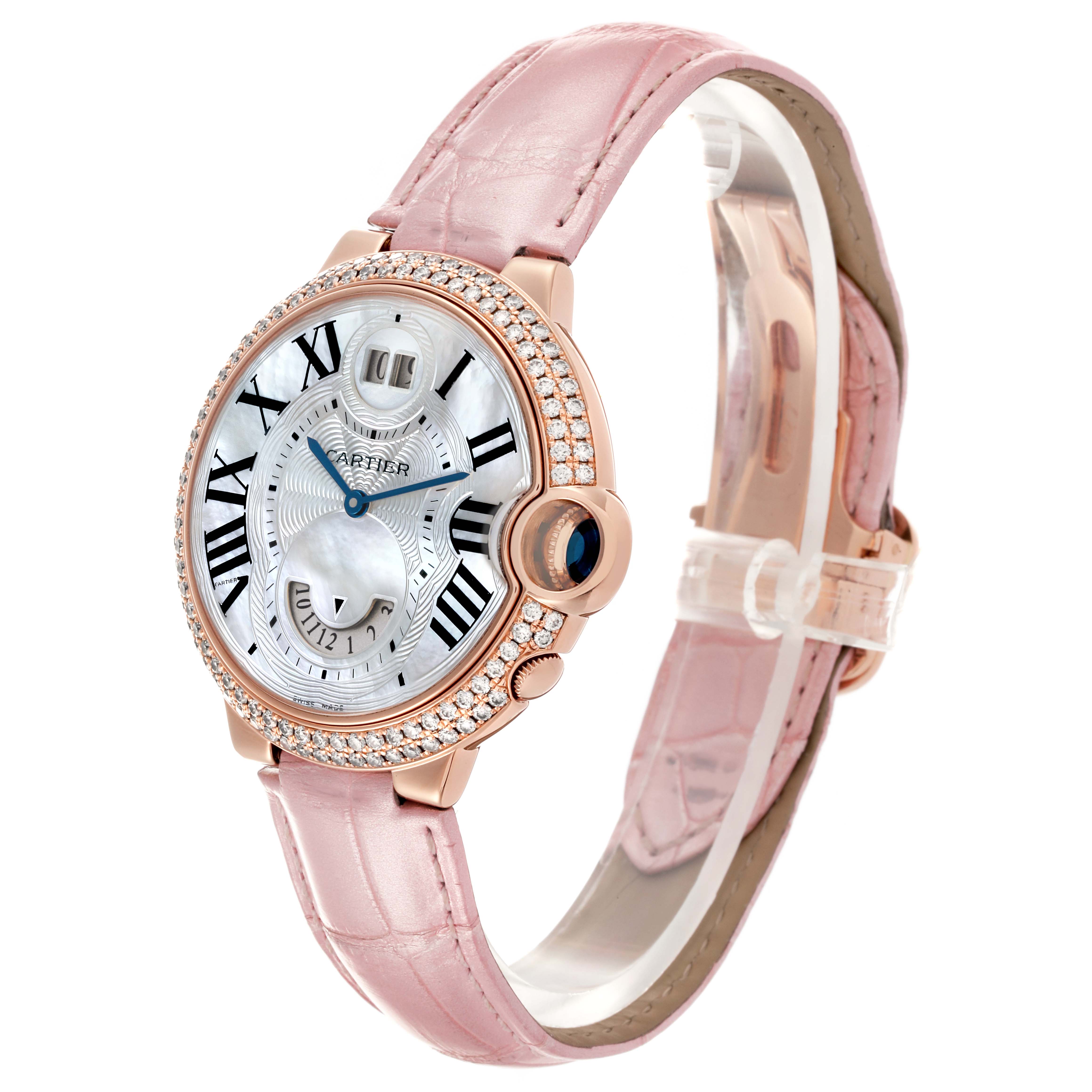 The Cartier Ballon Bleu WE902018 Women's Rose Gold Mother of Pearl Dial WE902018 Women's Rose Gold Mother of Pearl Dial watch is shown at a three-quarter angle, displaying the face, bezel, and pink leather strap.