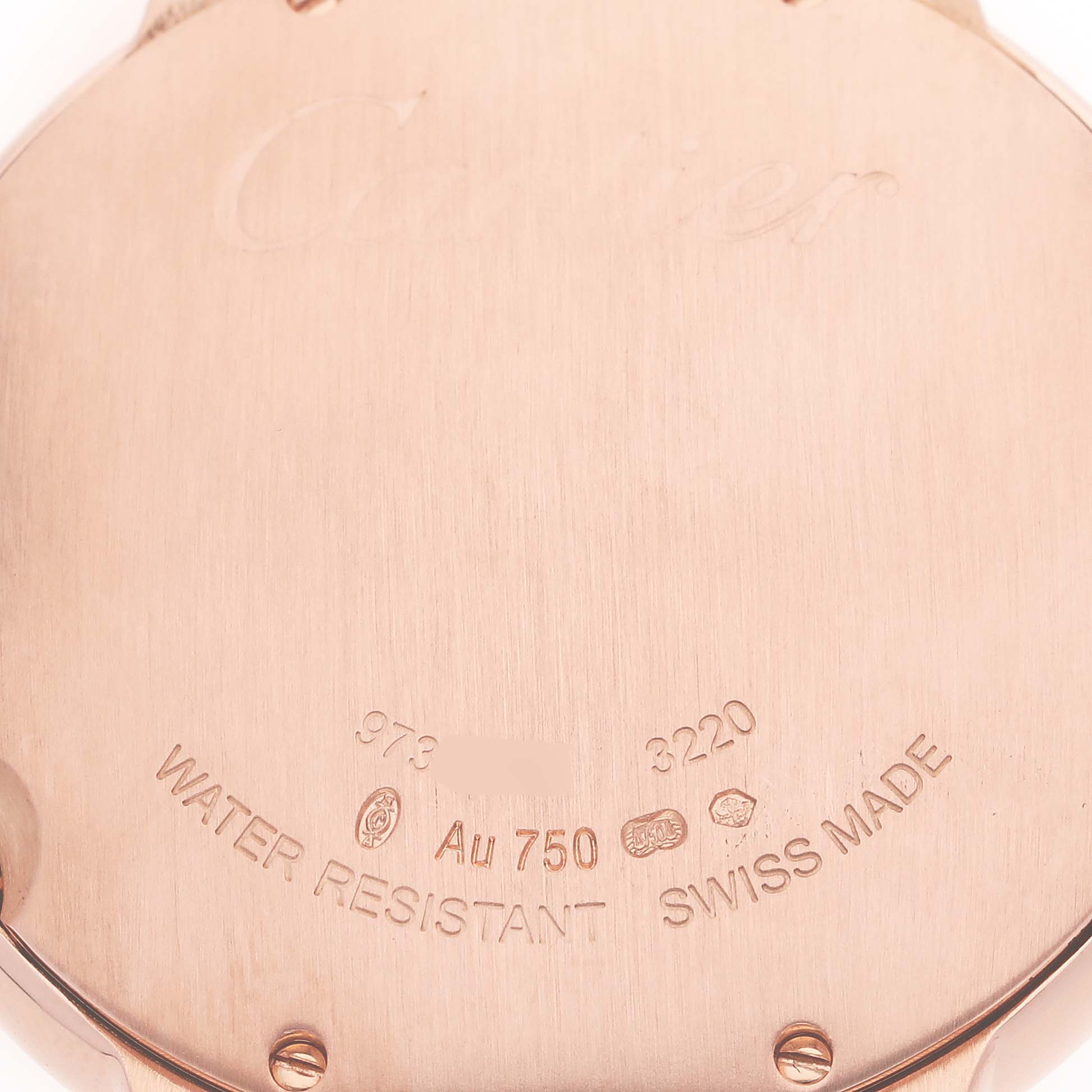 The image shows the back casing of the Cartier Ballon Bleu WE902018 Women's Rose Gold Mother of Pearl Dial WE902018 Women's Rose Gold Mother of Pearl Dial watch, highlighting its inscriptions and metal details.