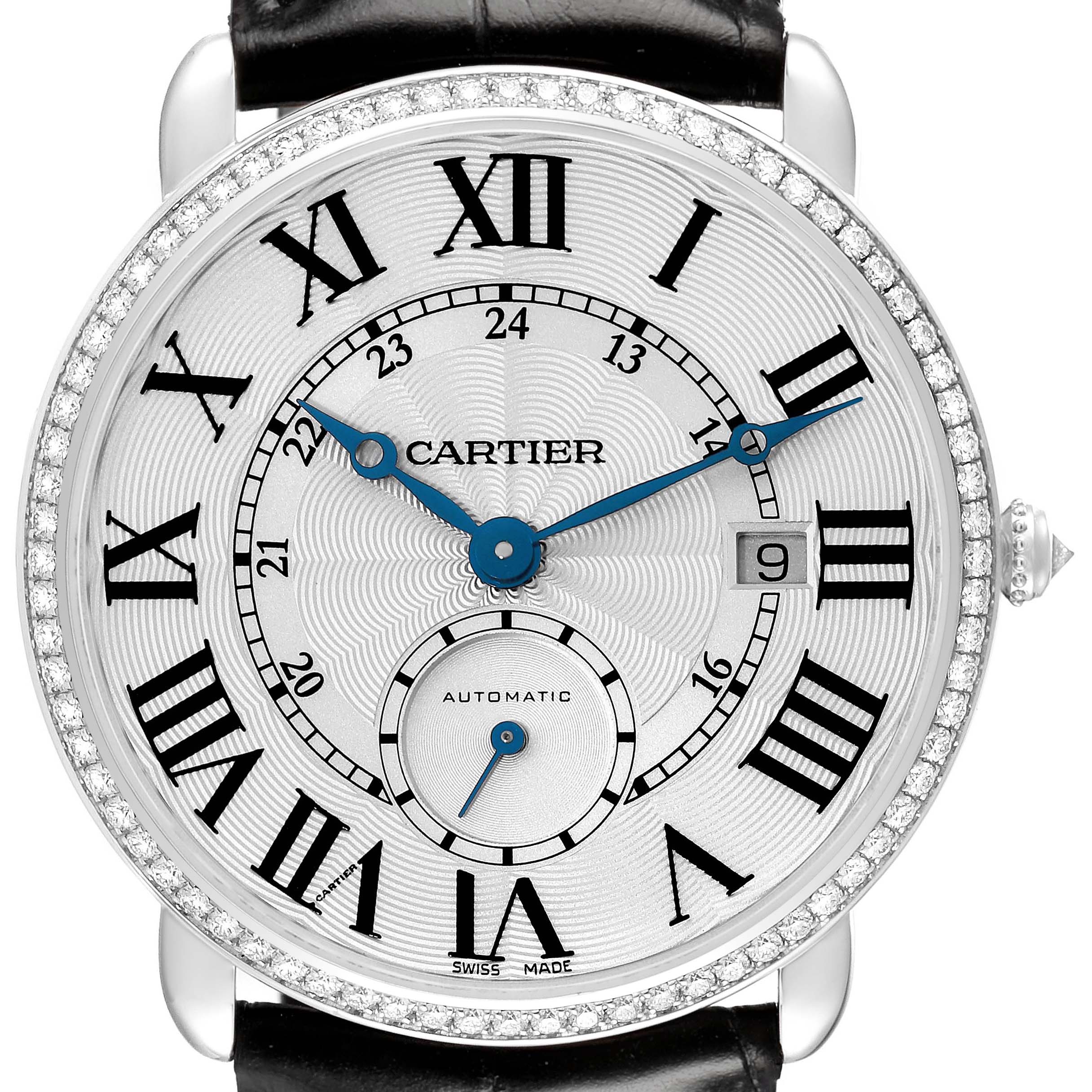 The Cartier Ronde WR007018 Men's White Gold Silver Dial watch is shown from the front, highlighting its dial, Roman numerals, blue hands, and diamond bezel.