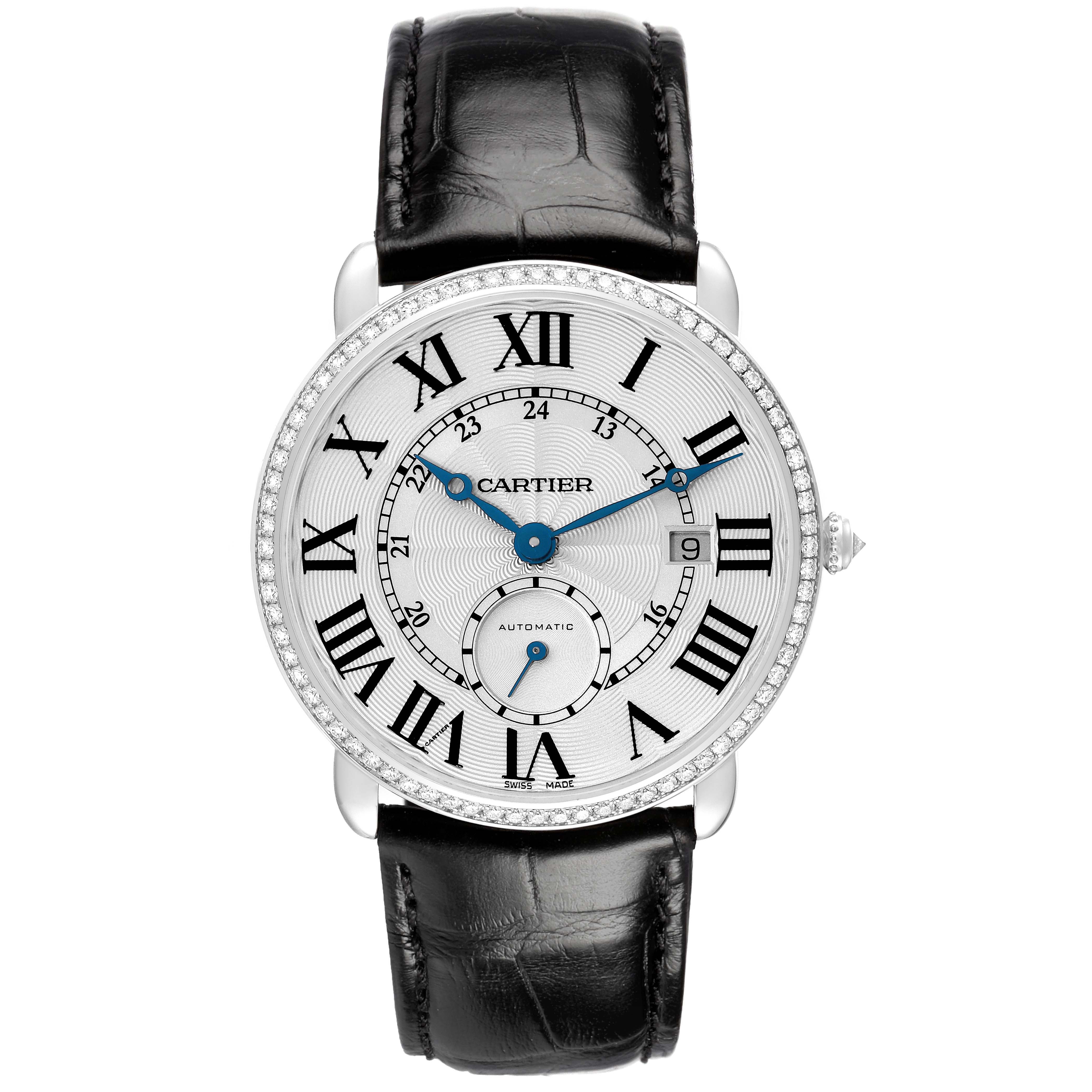 The Cartier Ronde WR007018 Men's White Gold Silver Dial watch is shown from a top-down angle, highlighting its dial, Roman numerals, and black leather strap.