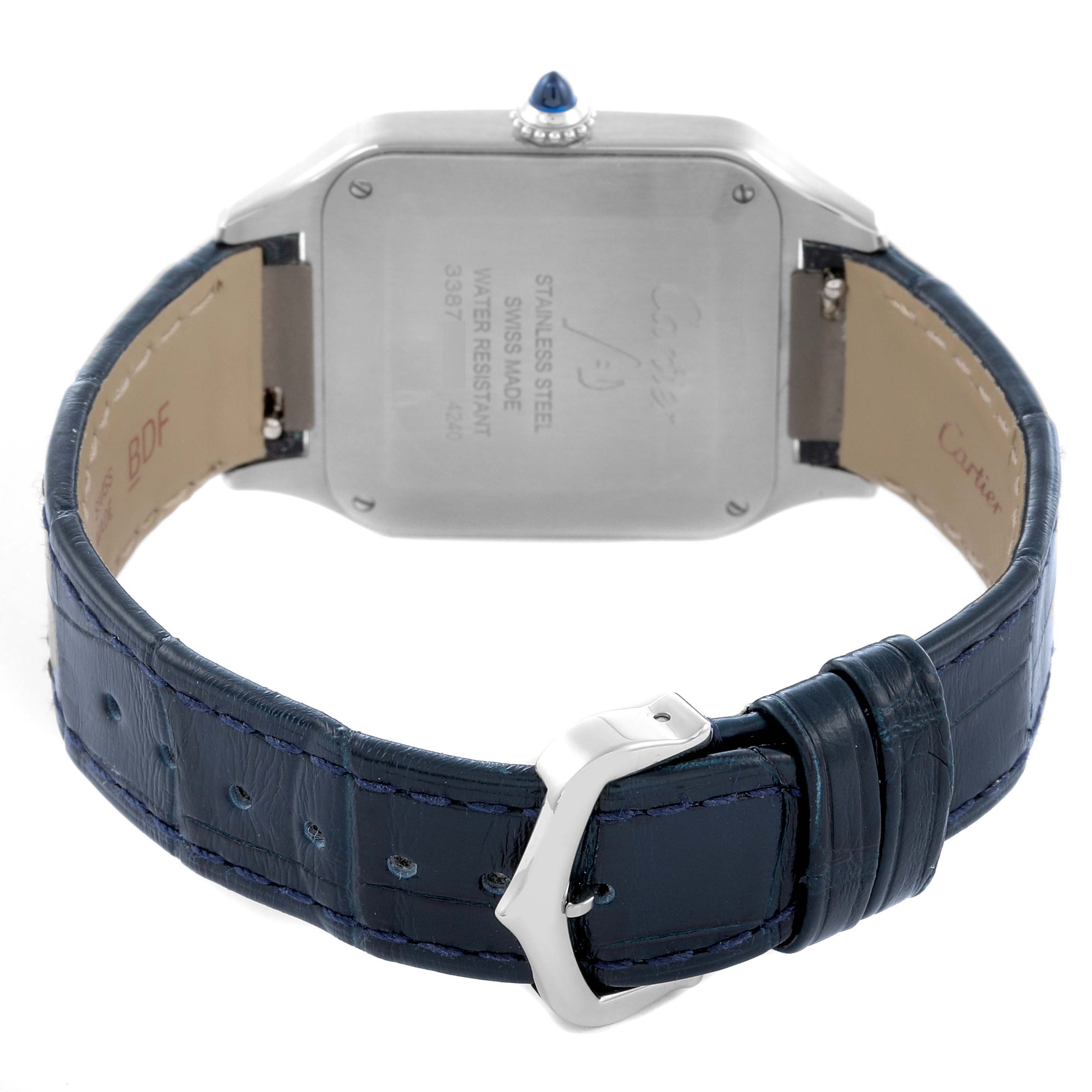 The image shows the back view of the Cartier Santos Dumont WSSA0022 Men
s Stainless Steel Silver Dial WSSA0022 Men
s Stainless Steel Silver Dial watch, highlighting the case back and blue leather strap with a buckle.