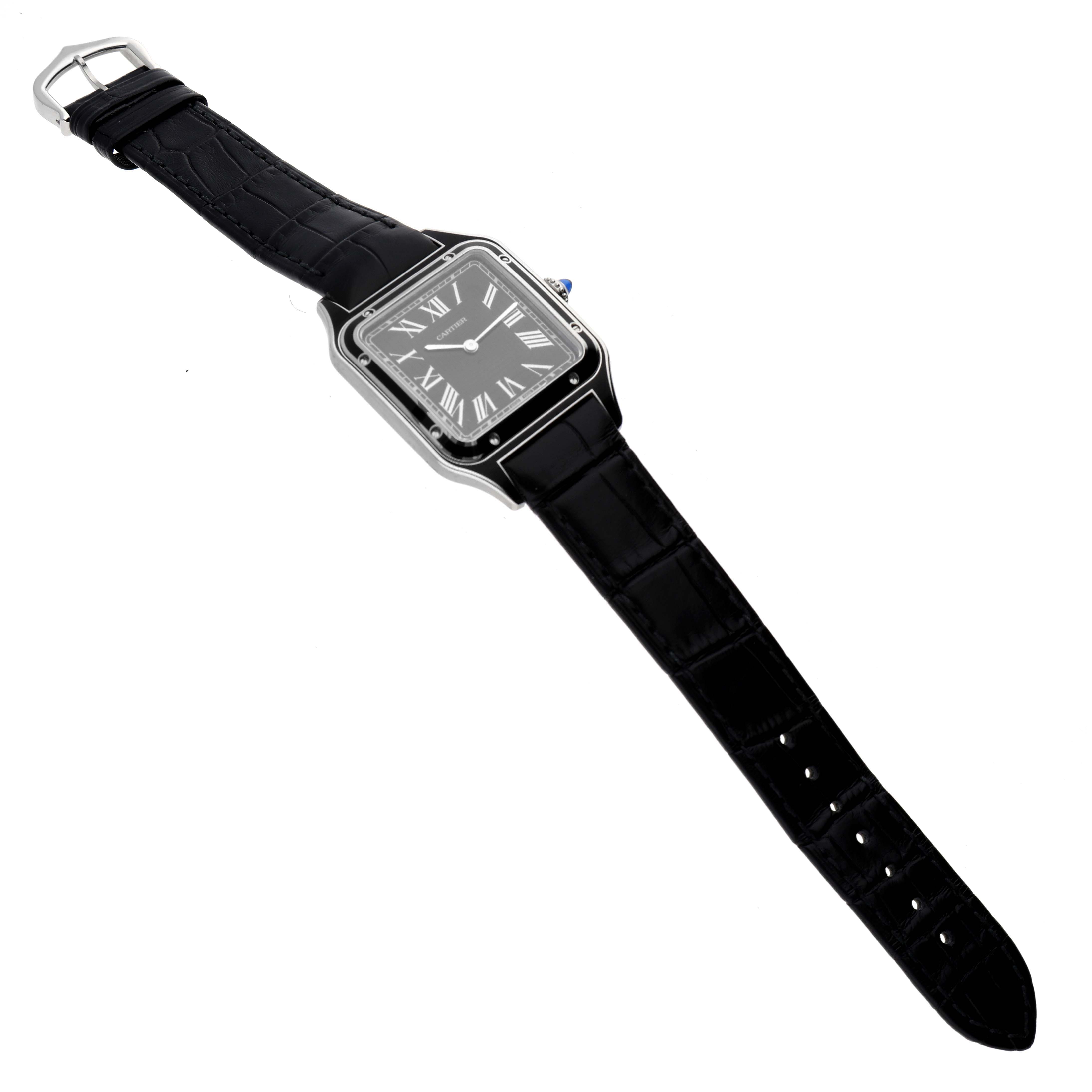 The Cartier Santos Dumont WSSA0046 Men's Stainless Steel Black Dial WSSA0046 Men's Stainless Steel Black Dial watch is shown at an angled top view, featuring the face, bezel, and full black leather strap.