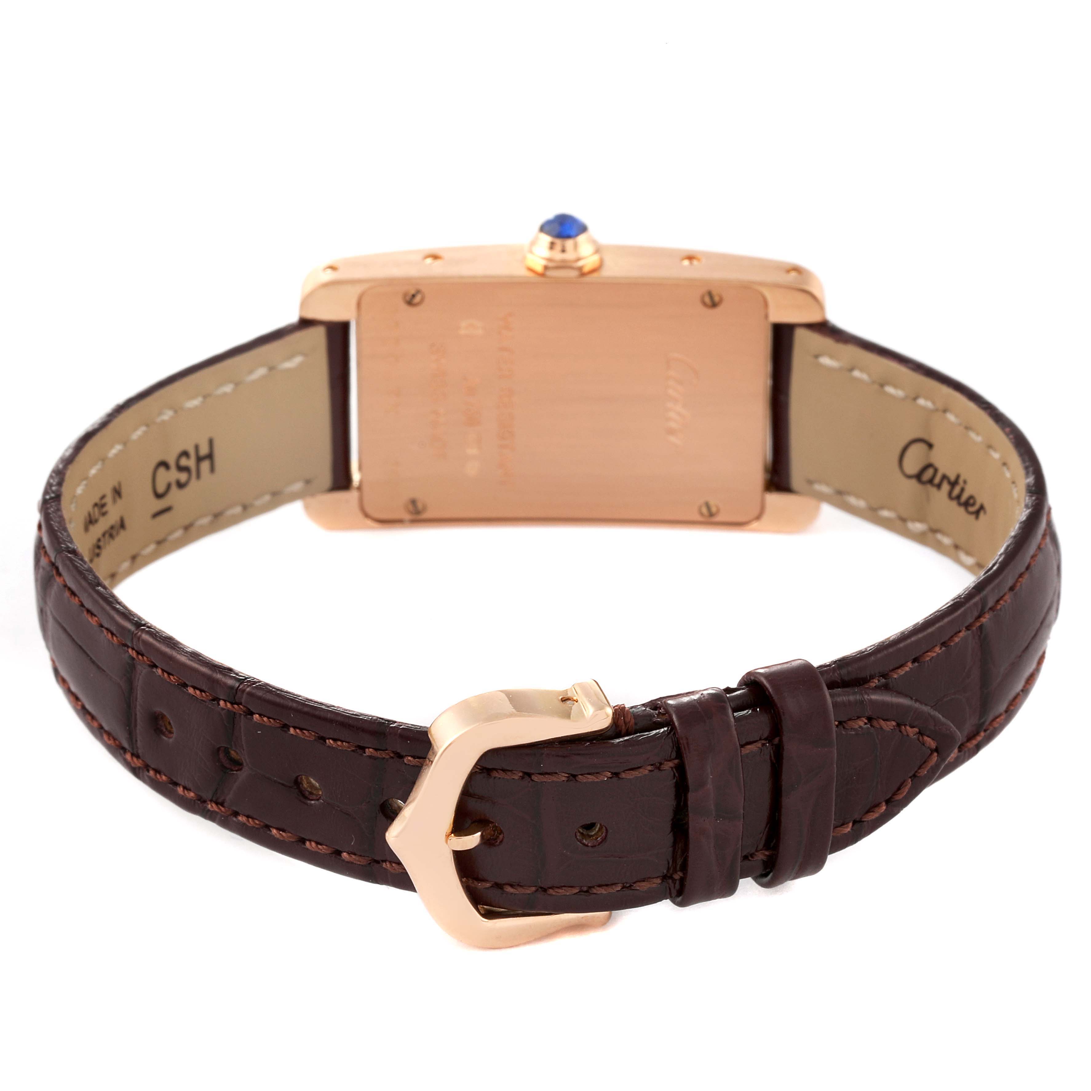 The image shows the back view of the Cartier Tank Americaine W2607456 Women
s Rose Gold Silver Dial W2607456 Women
s Rose Gold Silver Dial watch, highlighting its brown leather strap and buckle.
