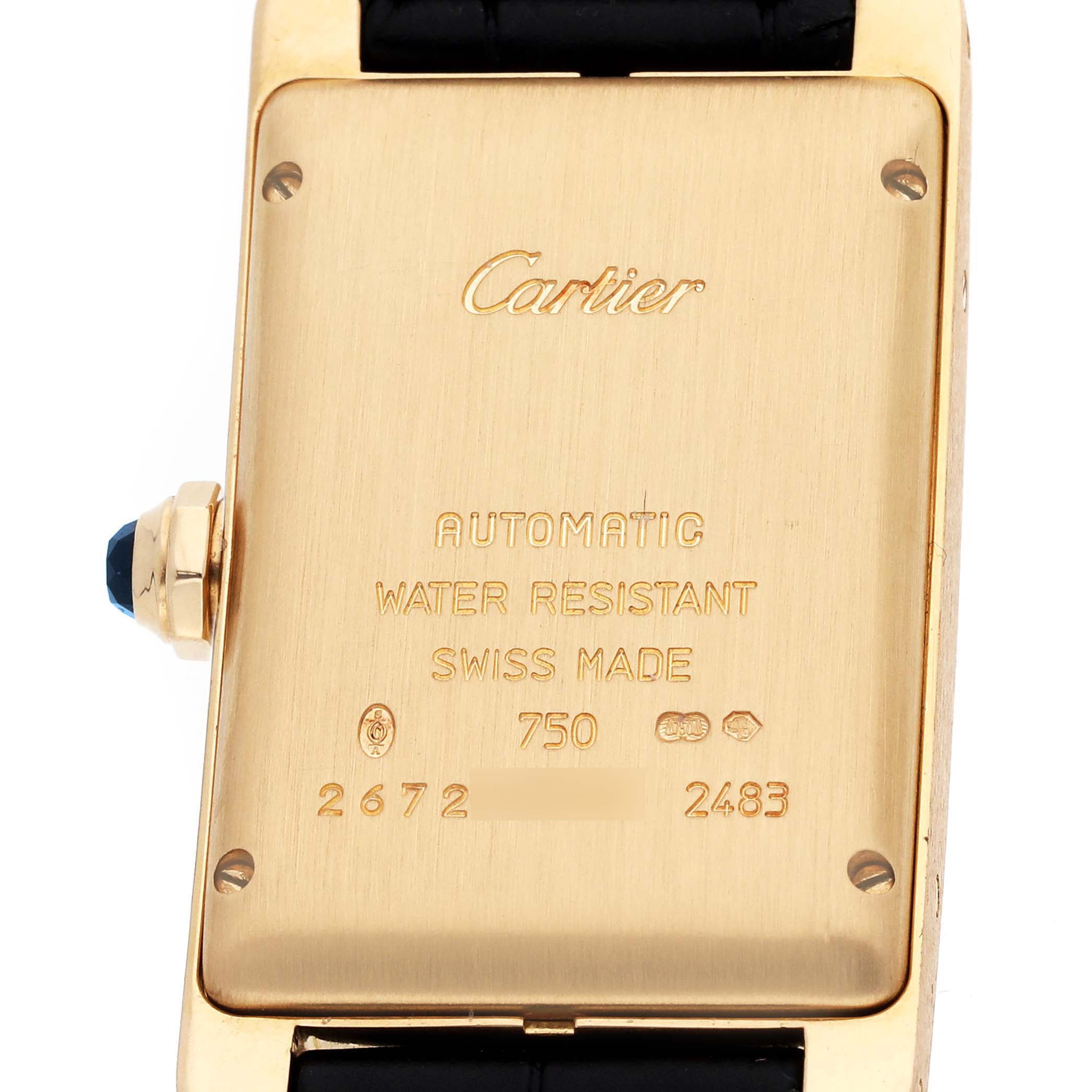 The image shows the back case of the Cartier Tank Americaine W2603556 Men's Yellow Gold Silver Dial watch with engraved details and part of the strap.