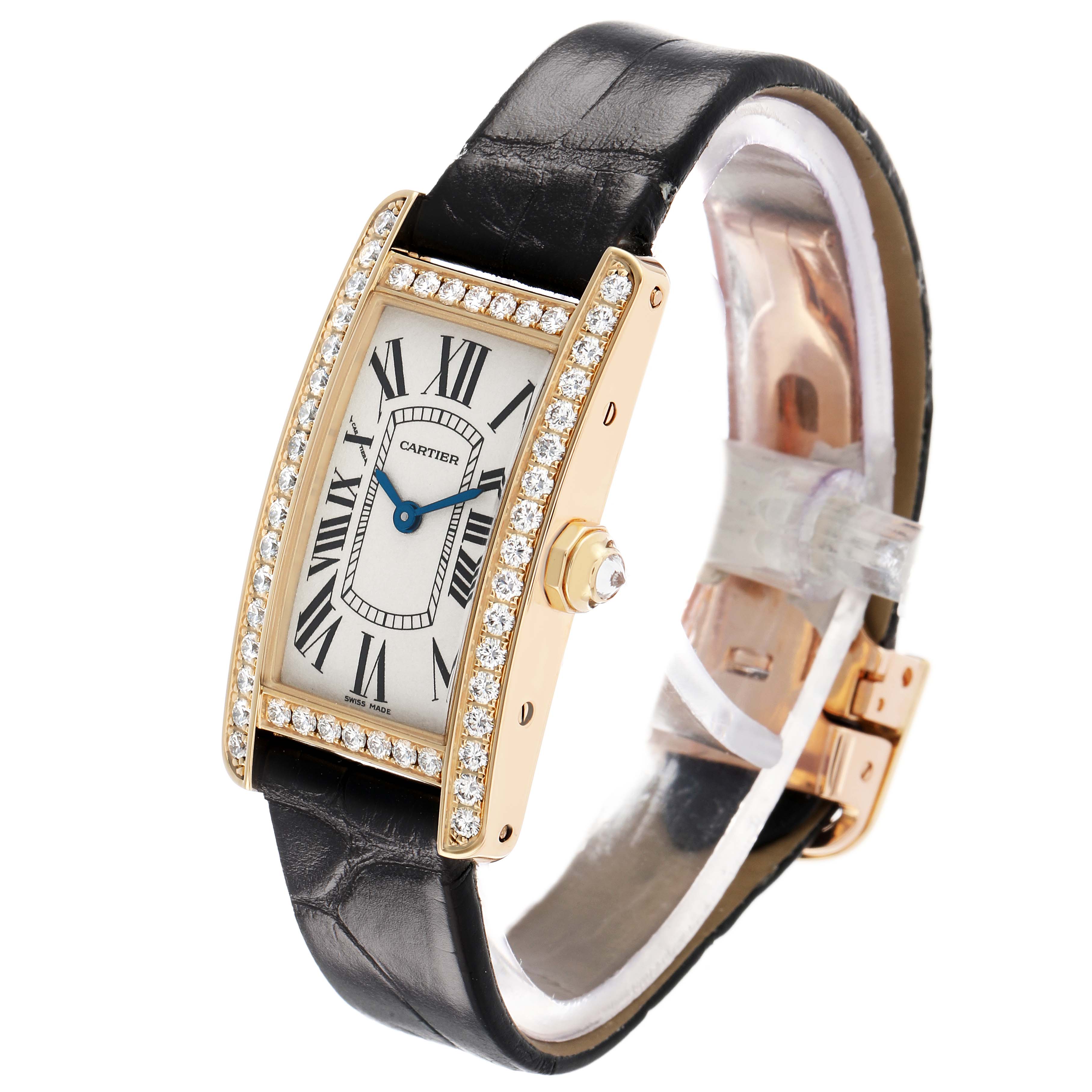 The Cartier Tank Américaine watch is shown at an angled side view, displaying its face, diamond-set bezel, crown, and leather strap.