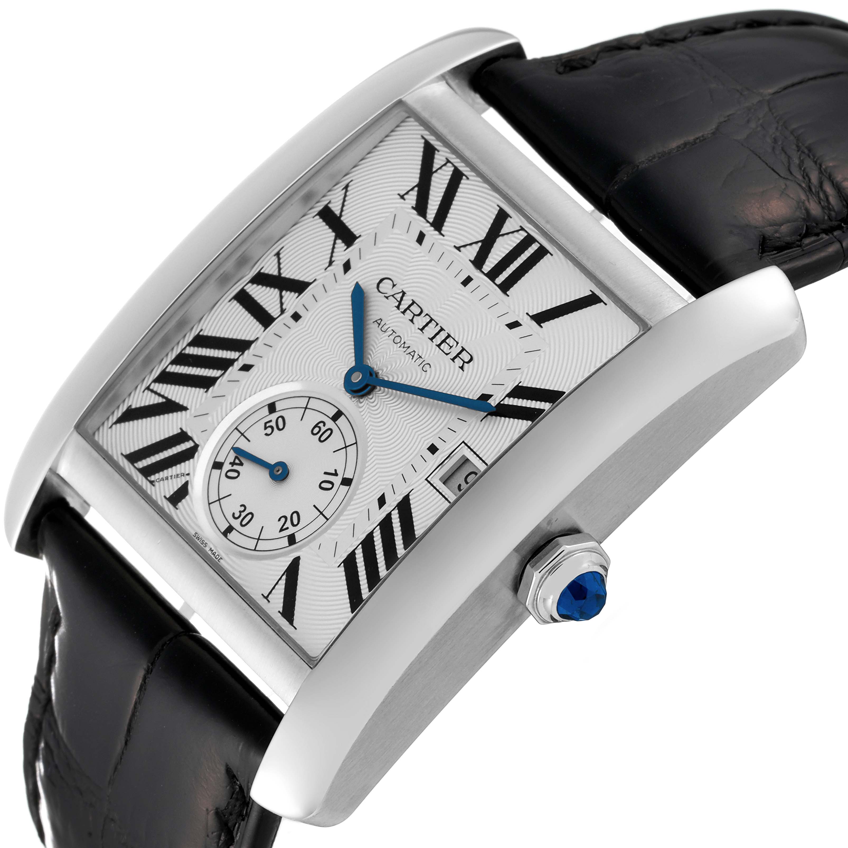 The image shows a Cartier Tank MC W5330003 Men
s Stainless Steel Silver Dial W5330003 Men
s Stainless Steel Silver Dial watch from an angled side view, highlighting its dial, Roman numerals, and crown with a blue gem.