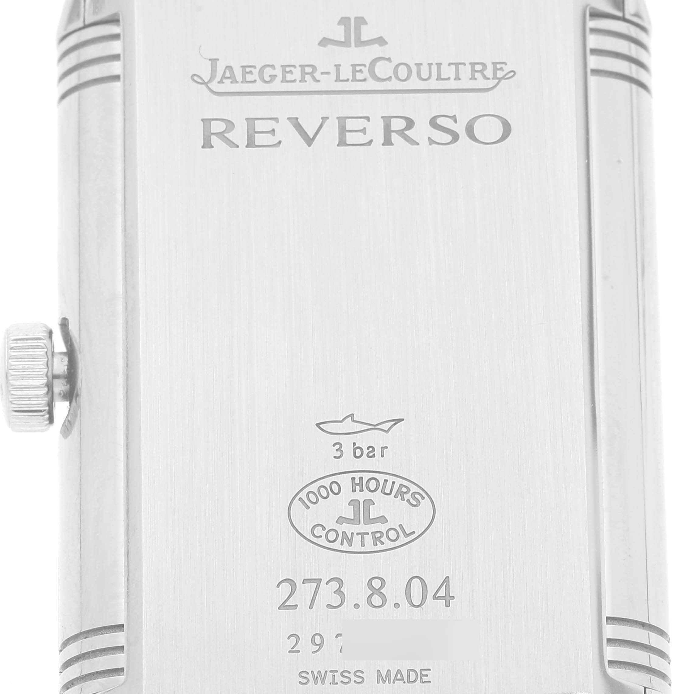 The image shows the back case of the Jaeger-LeCoultre Reverso model, highlighting engravings and the crown from a side angle.