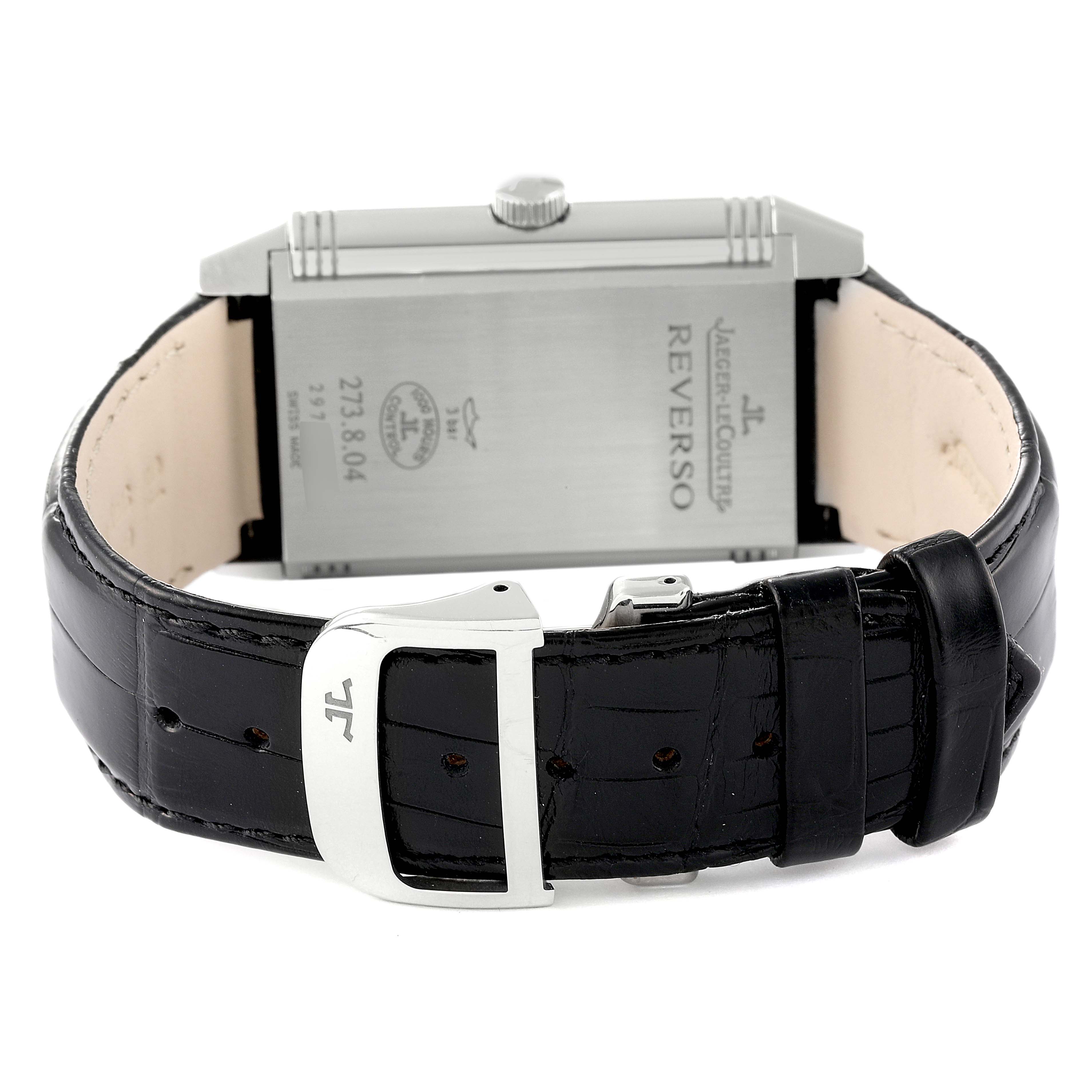The image shows the Jaeger LeCoultre Reverso Q3738420 Men
s Stainless Steel Silver Dial Q3738420 Men
s Stainless Steel Silver Dial watch from the back, including the case, crown, and leather strap with a buckle.