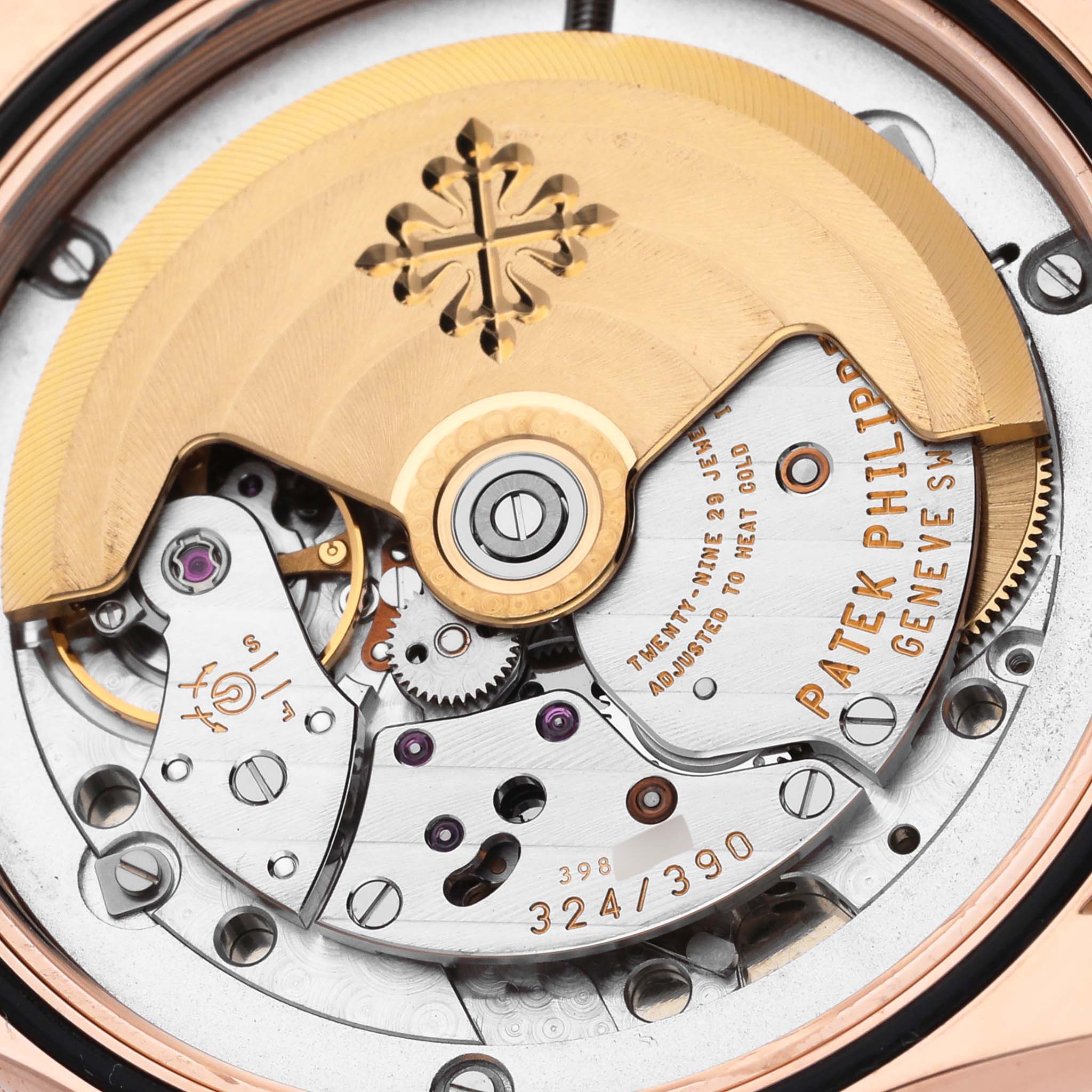 The image shows a close-up of the movement of a Patek Philippe Calatrava 5108R-001 Men's Rose Gold White Dial 5108R-001 Men's Rose Gold White Dial watch, highlighting the rotor and gears.