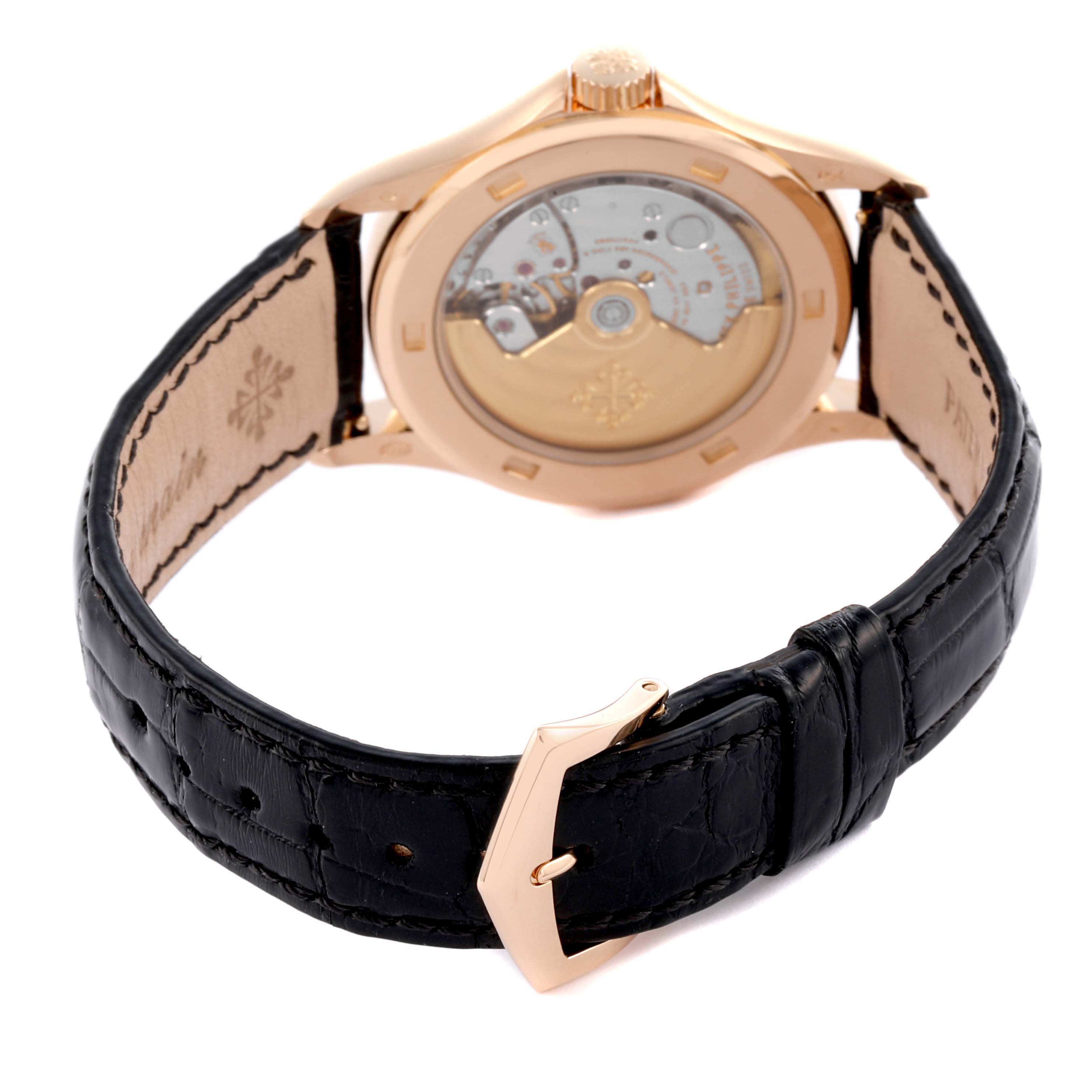 The Patek Philippe Calatrava 5108R-001 Men's Rose Gold White Dial 5108R-001 Men's Rose Gold White Dial watch is shown from the back, displaying its movement and leather strap with a buckle.