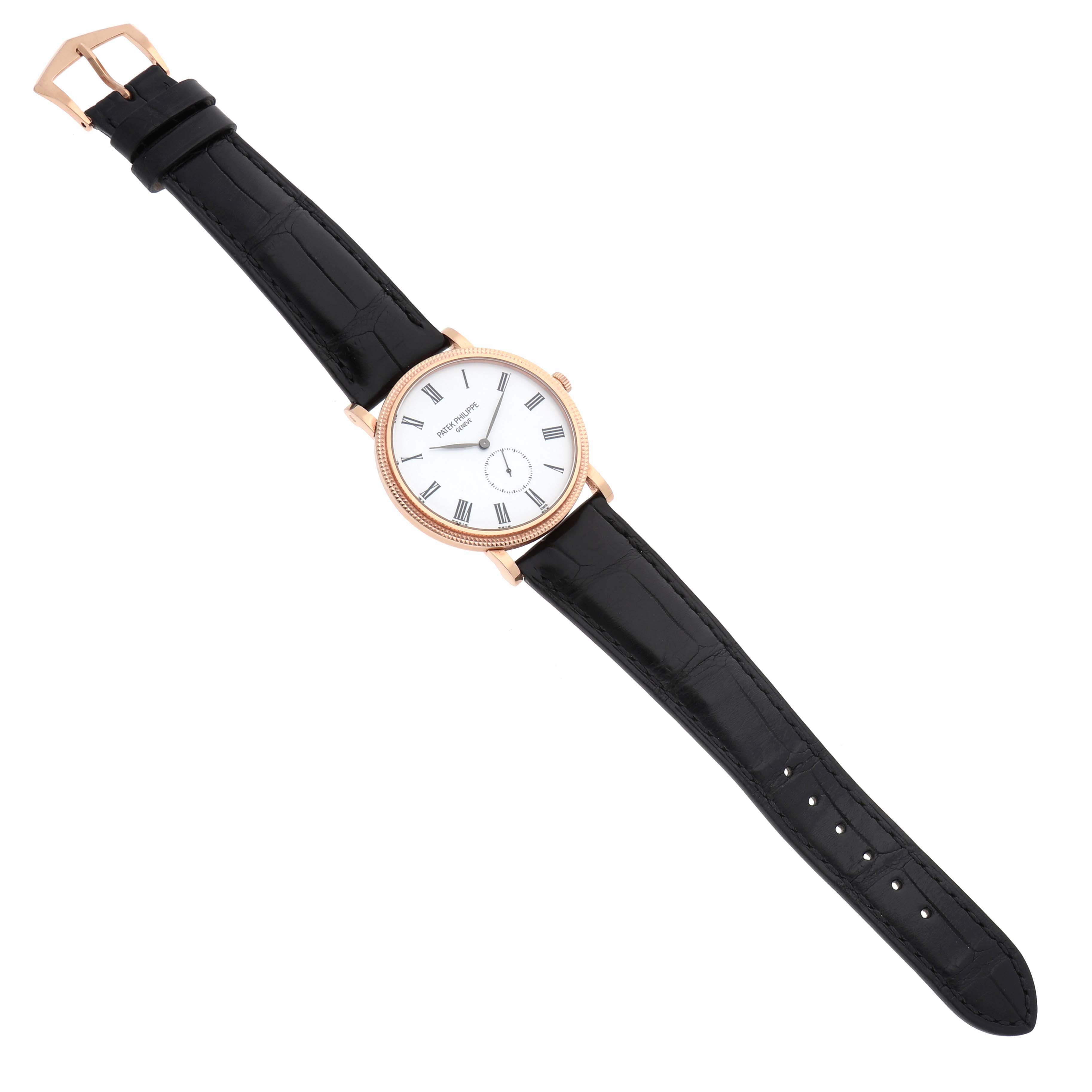 The Patek Philippe Calatrava 5116R Men's Rose Gold White Dial watch is shown from a top-down angle, displaying its face, bezel, leather strap, and buckle.