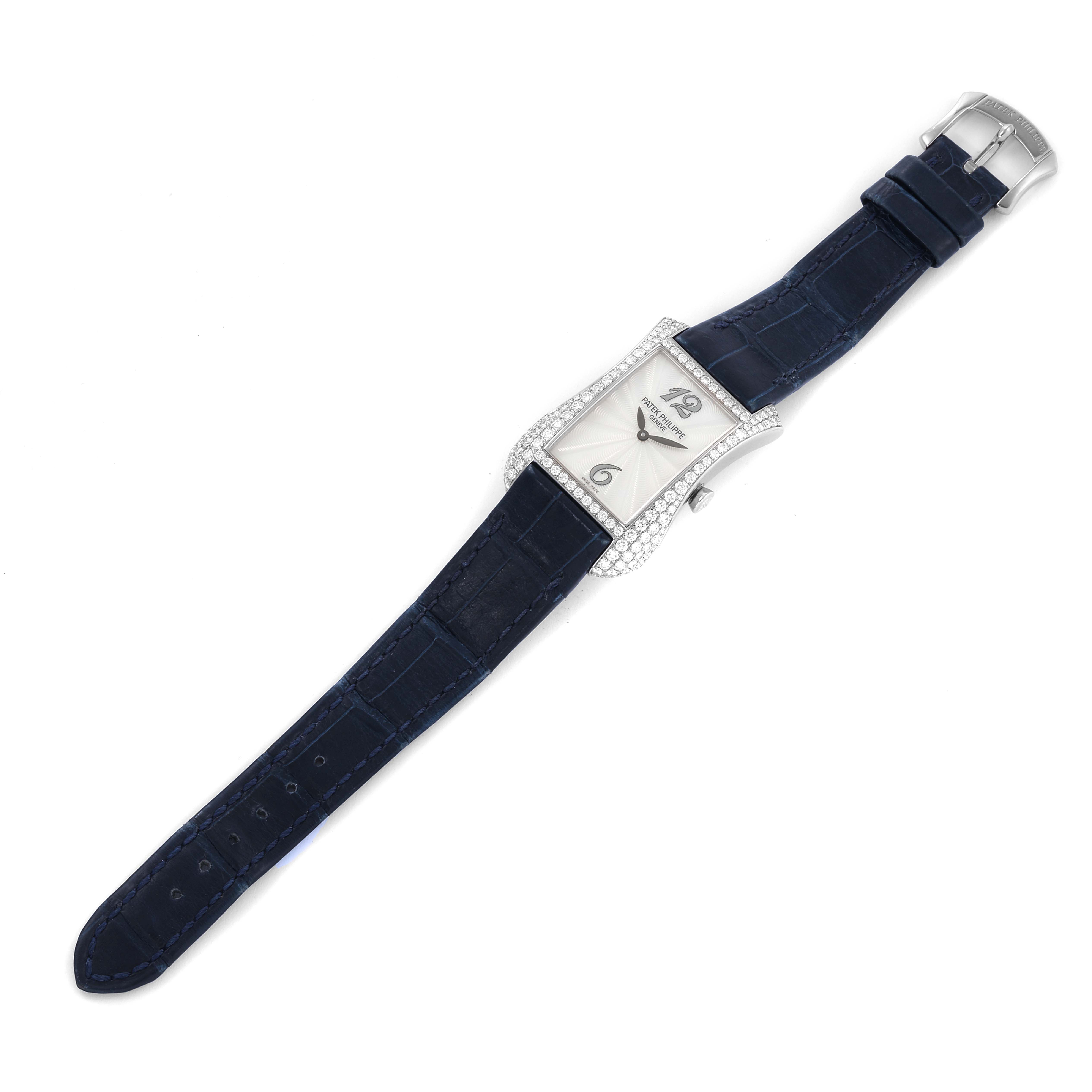 The Patek Philippe Gondolo 4972G-001 Women's White Gold Mother of Pearl Dial watch is shown from a top-down angle, displaying its rectangular dial, diamond-set bezel, and blue leather strap.