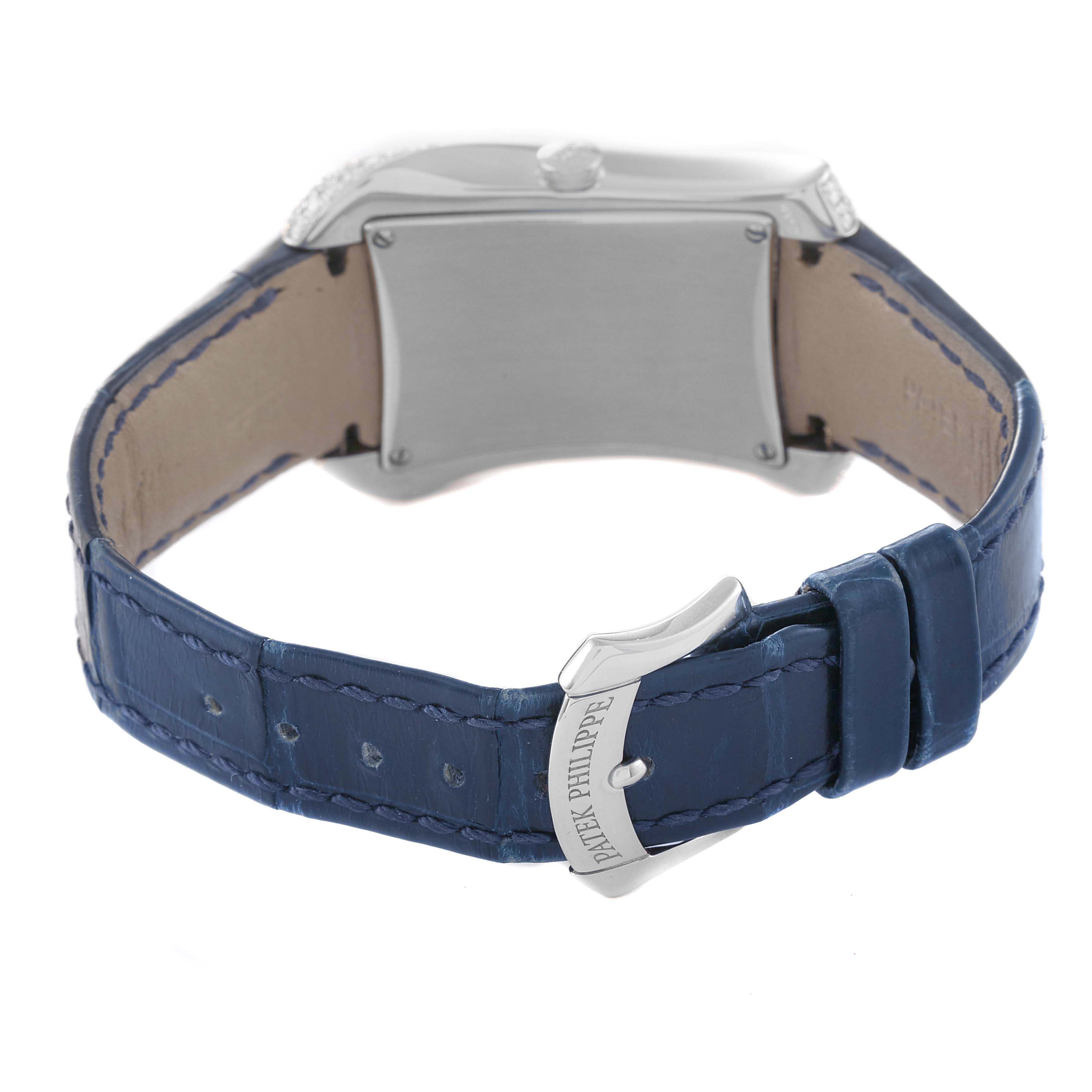 The image shows the rear view of a Patek Philippe Gondolo 4972G-001 Women's White Gold Mother of Pearl Dial watch, featuring the case back and blue leather strap with the brand's clasp.