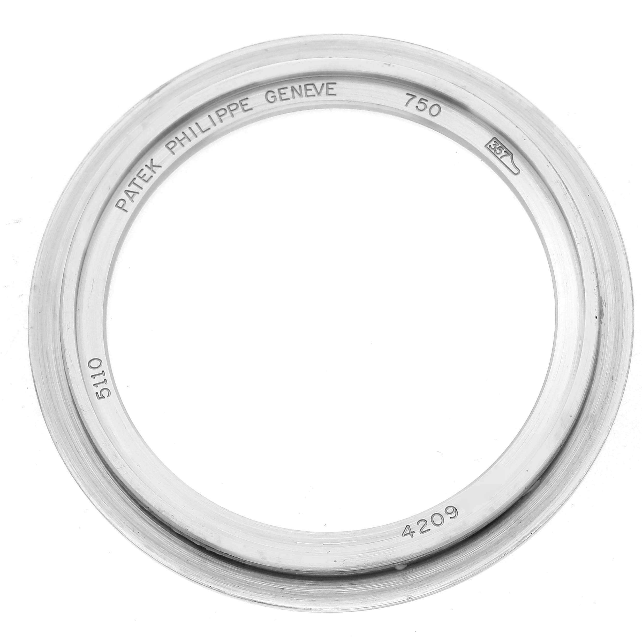 This image shows the bezel of the Patek Philippe Complications 5110G-001 Men's White Gold Silver Dial 5110G-001 Men's White Gold Silver Dial model, displaying engravings and markings.