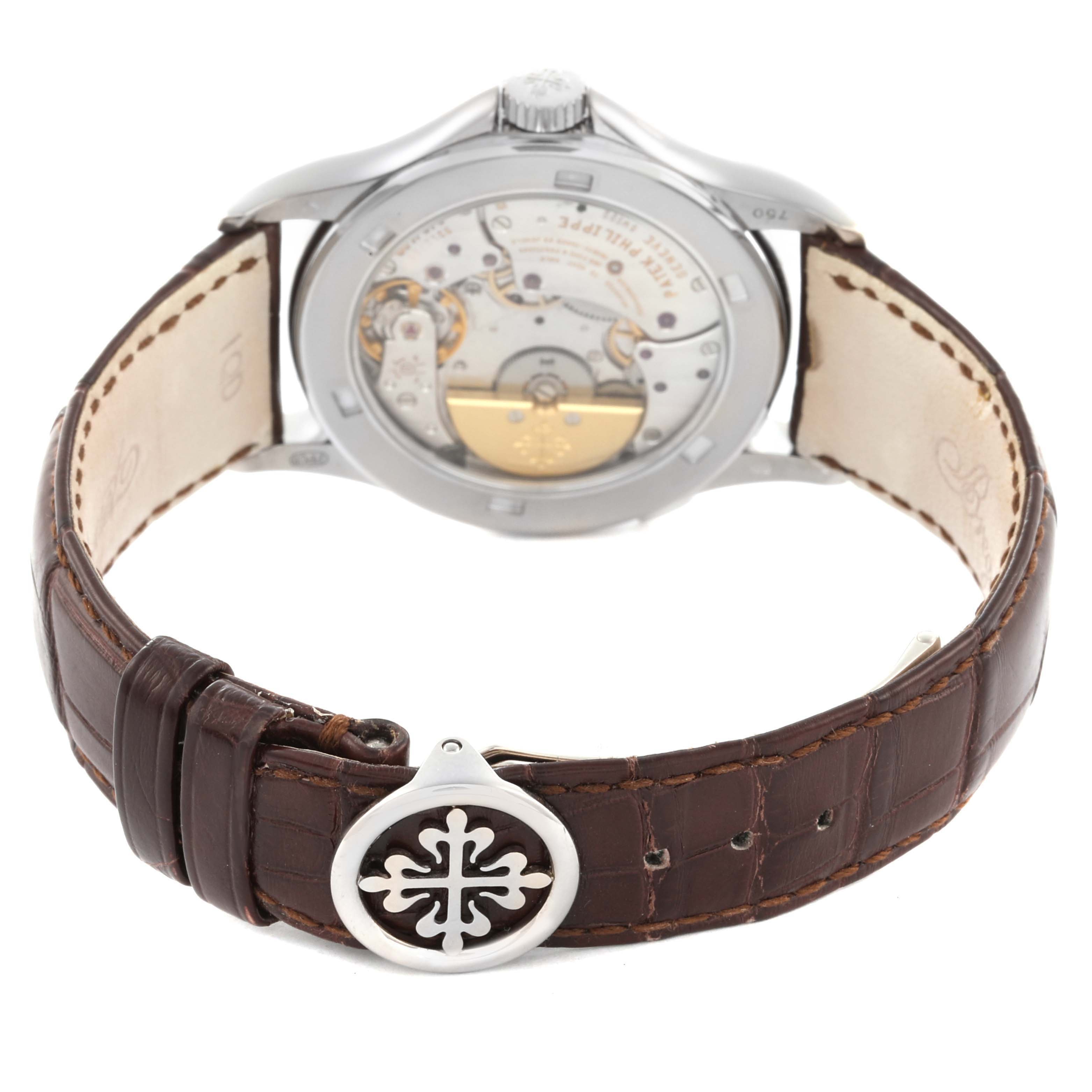 The image shows the Patek Philippe Complications 5110G-001 Men's White Gold Silver Dial 5110G-001 Men's White Gold Silver Dial watch from the back, revealing the movement and featuring a brown leather strap.