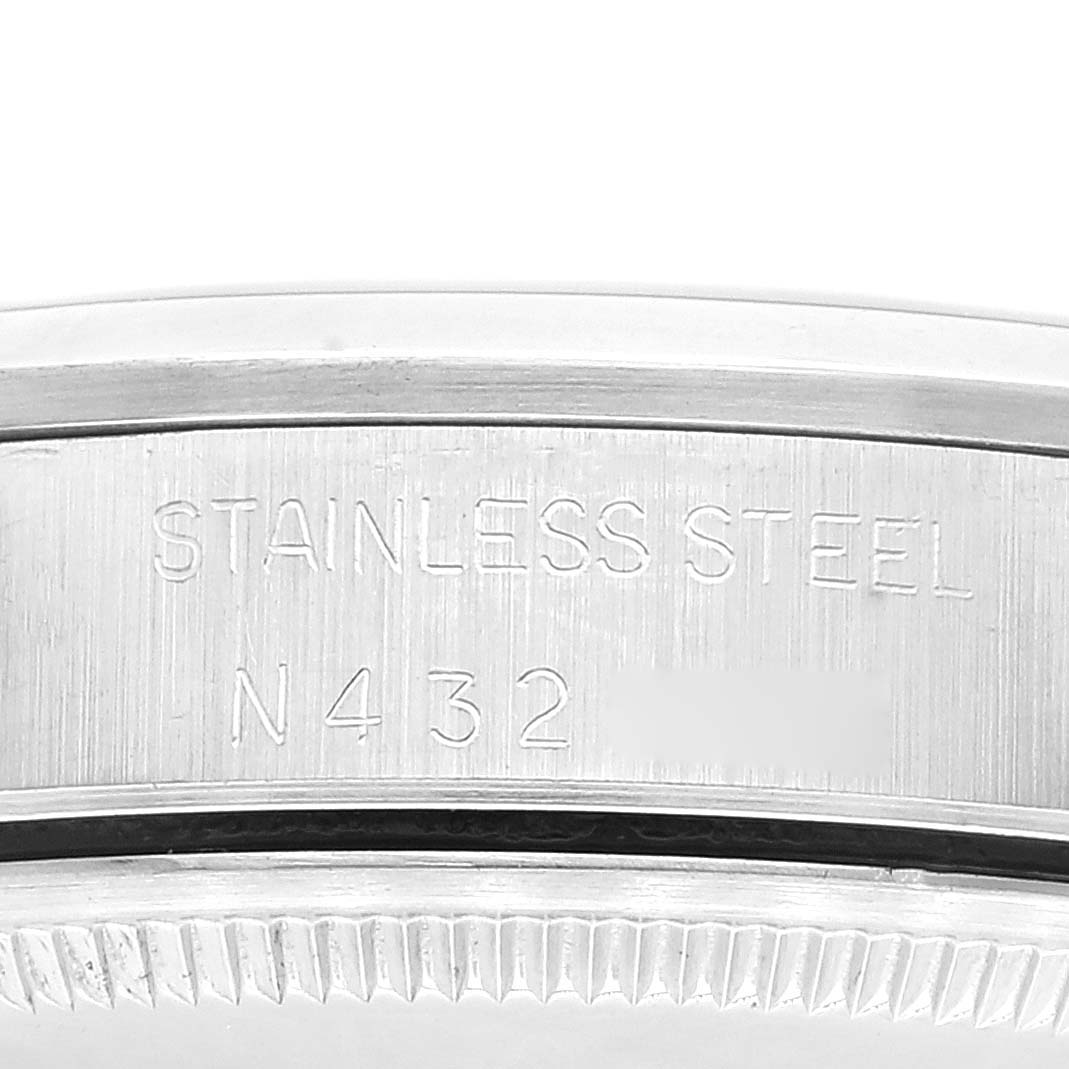 This image shows a close-up of the case back of a Rolex Air-King 14000 Men's Stainless Steel Pink Dial 14000 Men's Stainless Steel Pink Dial watch, highlighting the "Stainless Steel" engraving and a serial number.