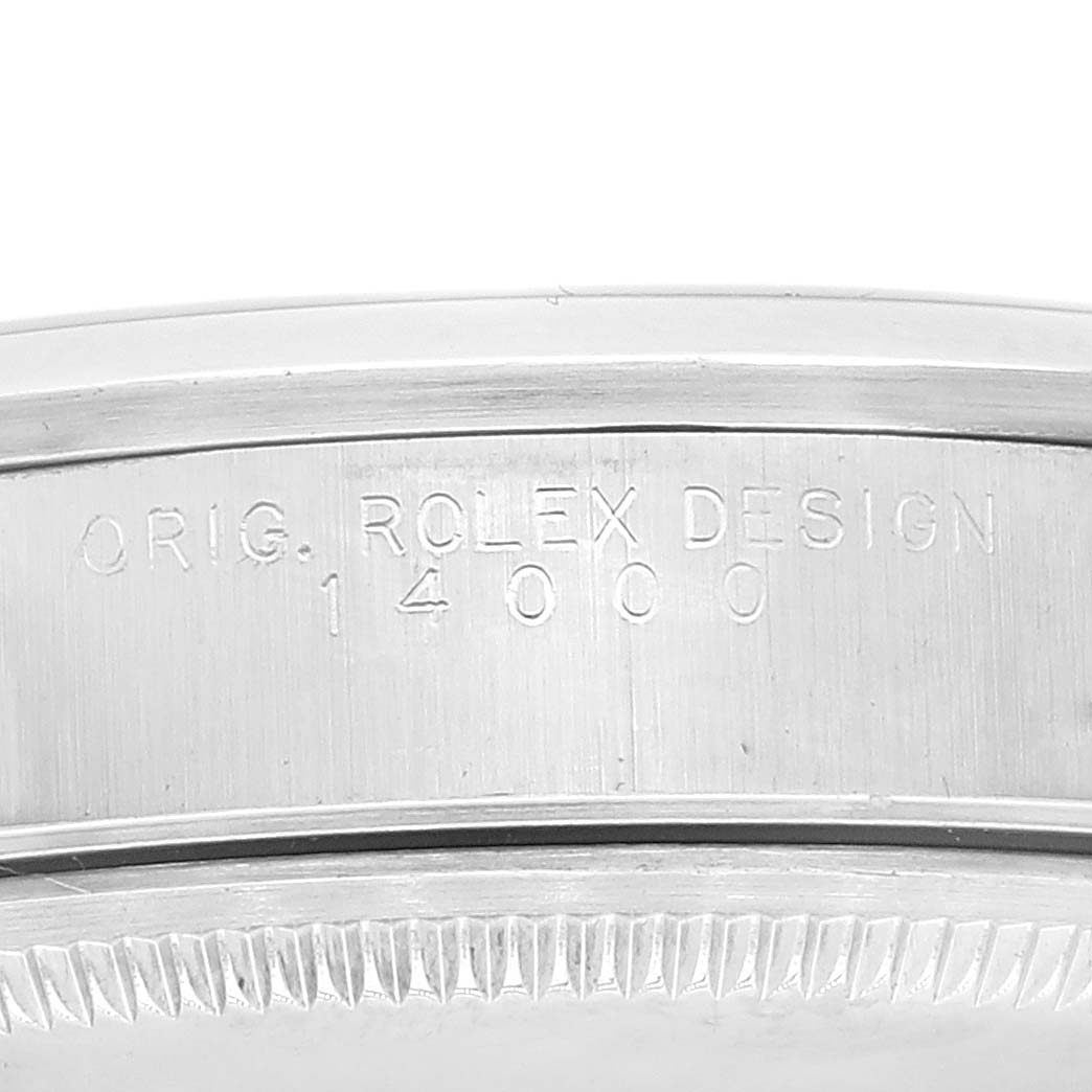 This image shows a close-up view of the case side engraving on a Rolex Air-King 14000 Men's Stainless Steel Silver Dial 14000 Men's Stainless Steel Silver Dial watch, displaying "ORIG. ROLEX DESIGN 14000."