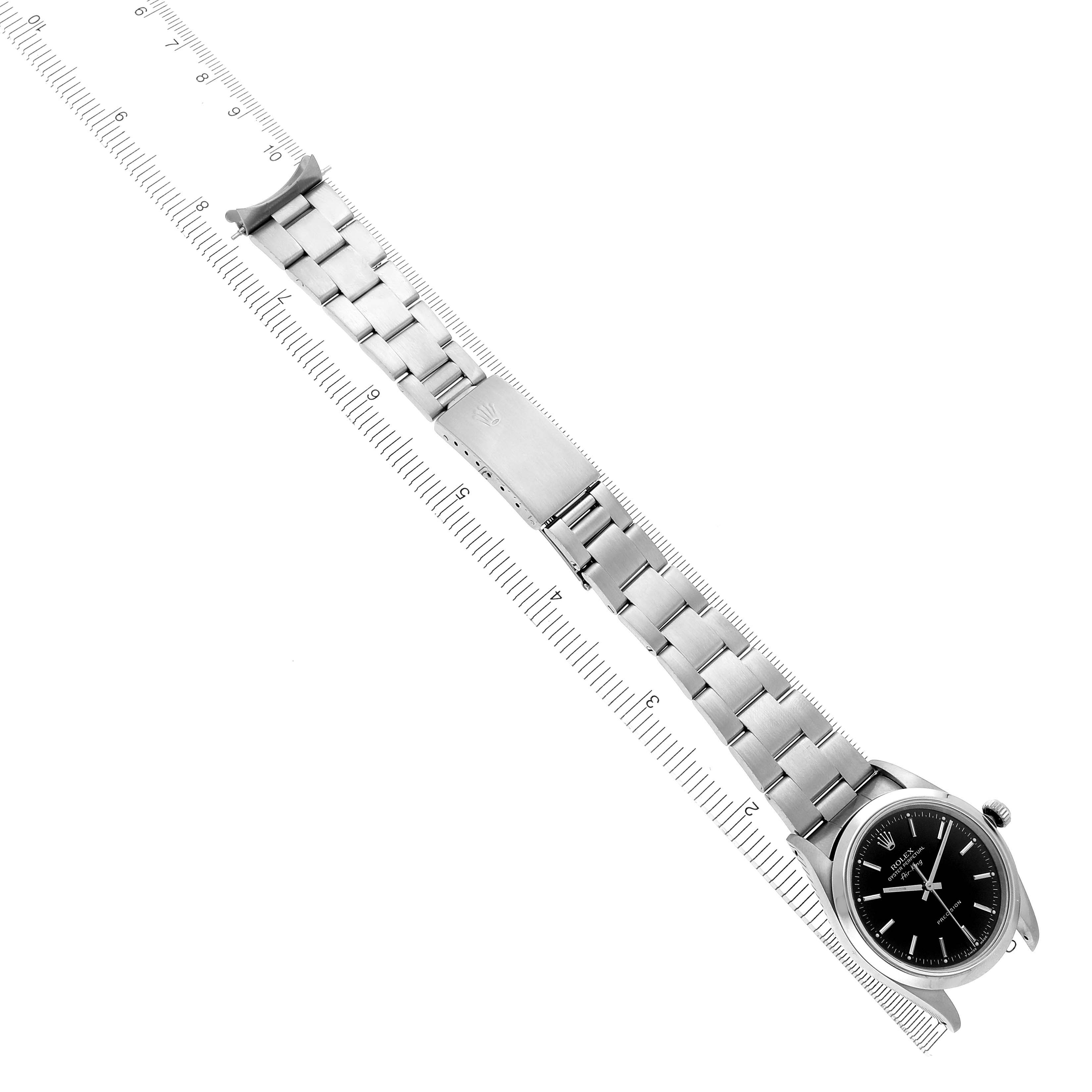 The Rolex Air-King 14000M Men's Stainless Steel Black Dial 14000M Men's Stainless Steel Black Dial watch is shown flat with the face, bracelet, and clasp visible, placed alongside a ruler for scale.