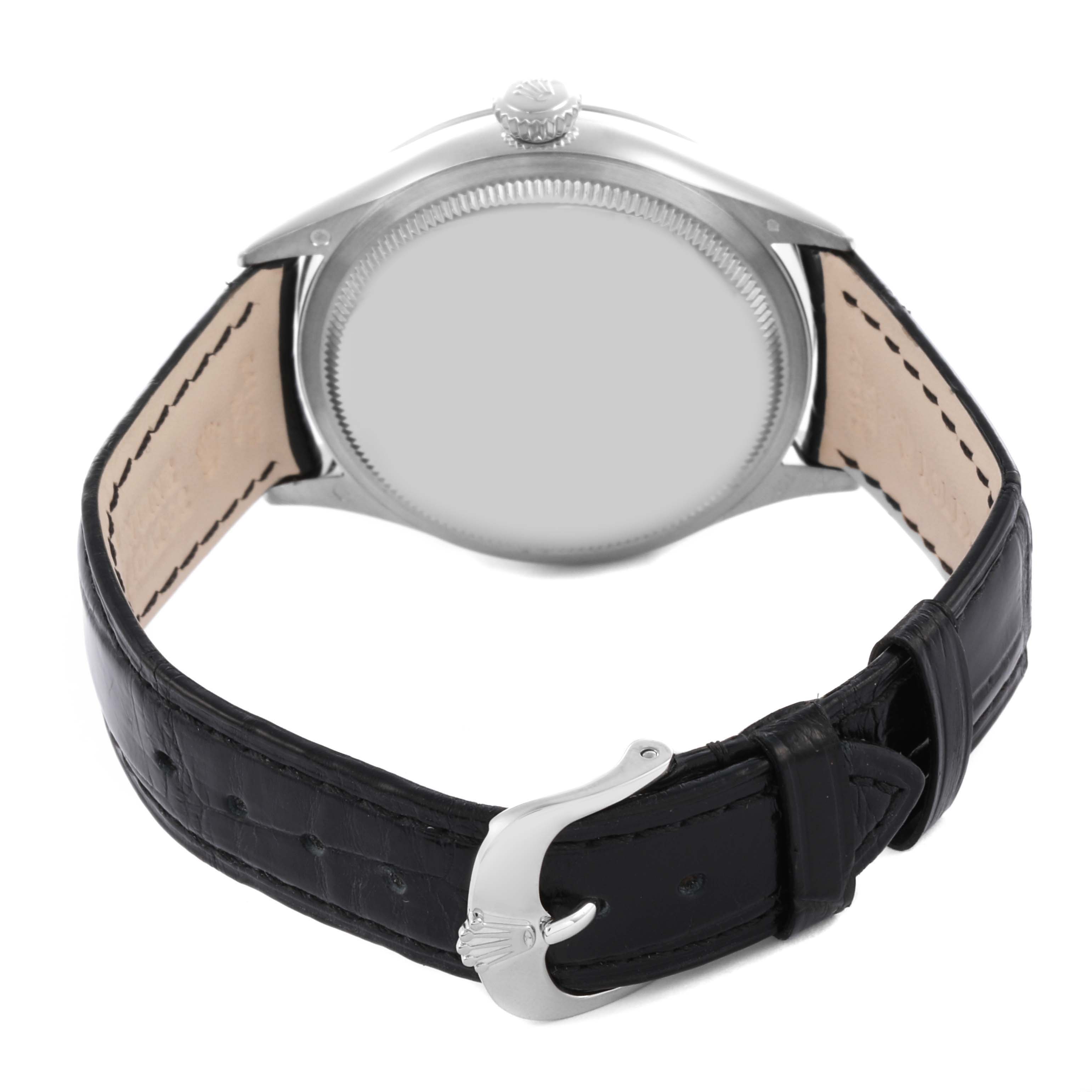 The Rolex Cellini 50509 Men's White Gold White Dial 50509 Men's White Gold White Dial watch is shown from the back, highlighting the case, crown, and black leather strap with buckle.