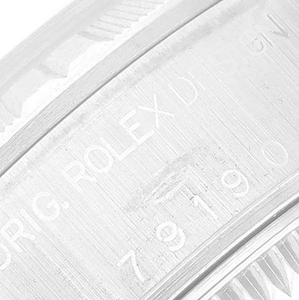 This image shows a close-up view of the serial number engraving on the case of a Rolex Date 79190 Women's Stainless Steel Pink Dial 79190 Women's Stainless Steel Pink Dial watch.