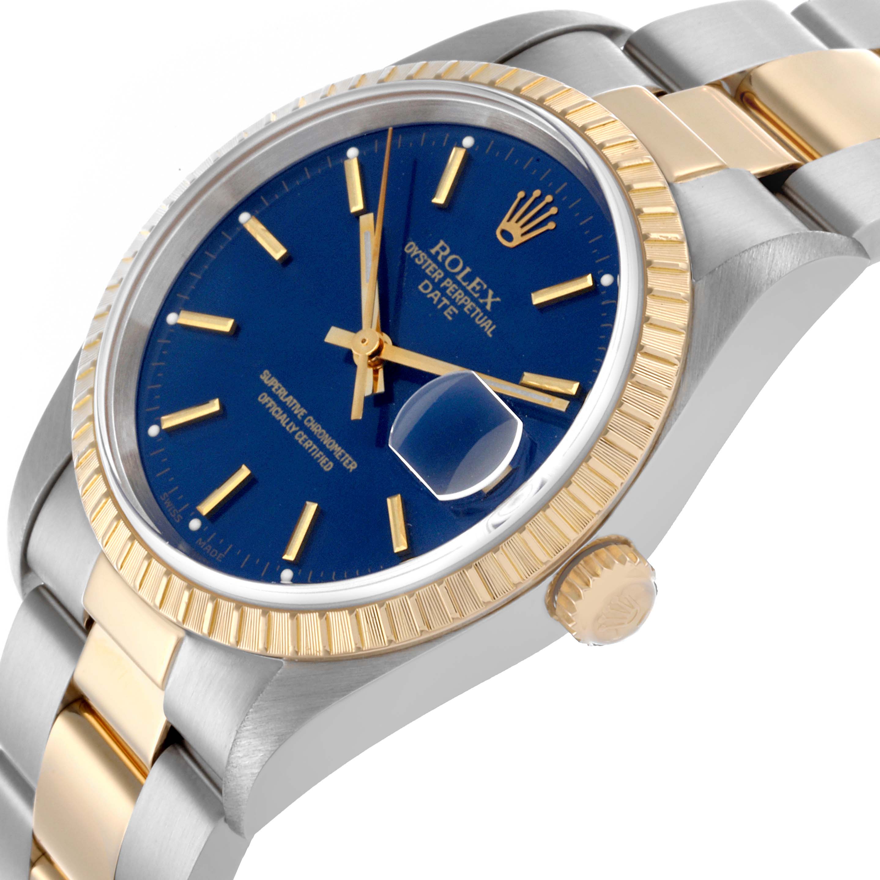 The Rolex Date 15223 Men
s Steel and Gold (two tone) Blue Dial 15223 Men
s Steel and Gold (two tone) Blue Dial watch is shown at an angled side view, highlighting the bezel, crown, and part of the bracelet.