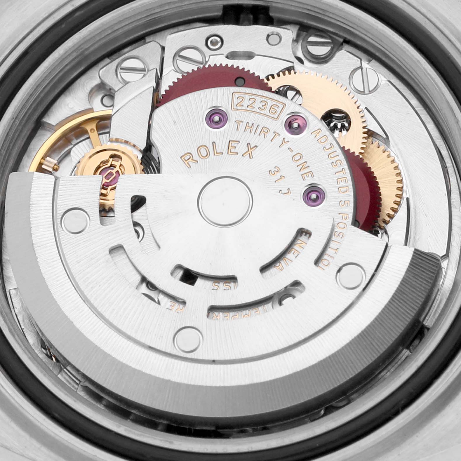 The image shows the movement mechanism of the Rolex Datejust 279173 Women's Steel and Gold (two tone) Silver Dial 279173 Women's Steel and Gold (two tone) Silver Dial watch, highlighting gears and engraved details.
