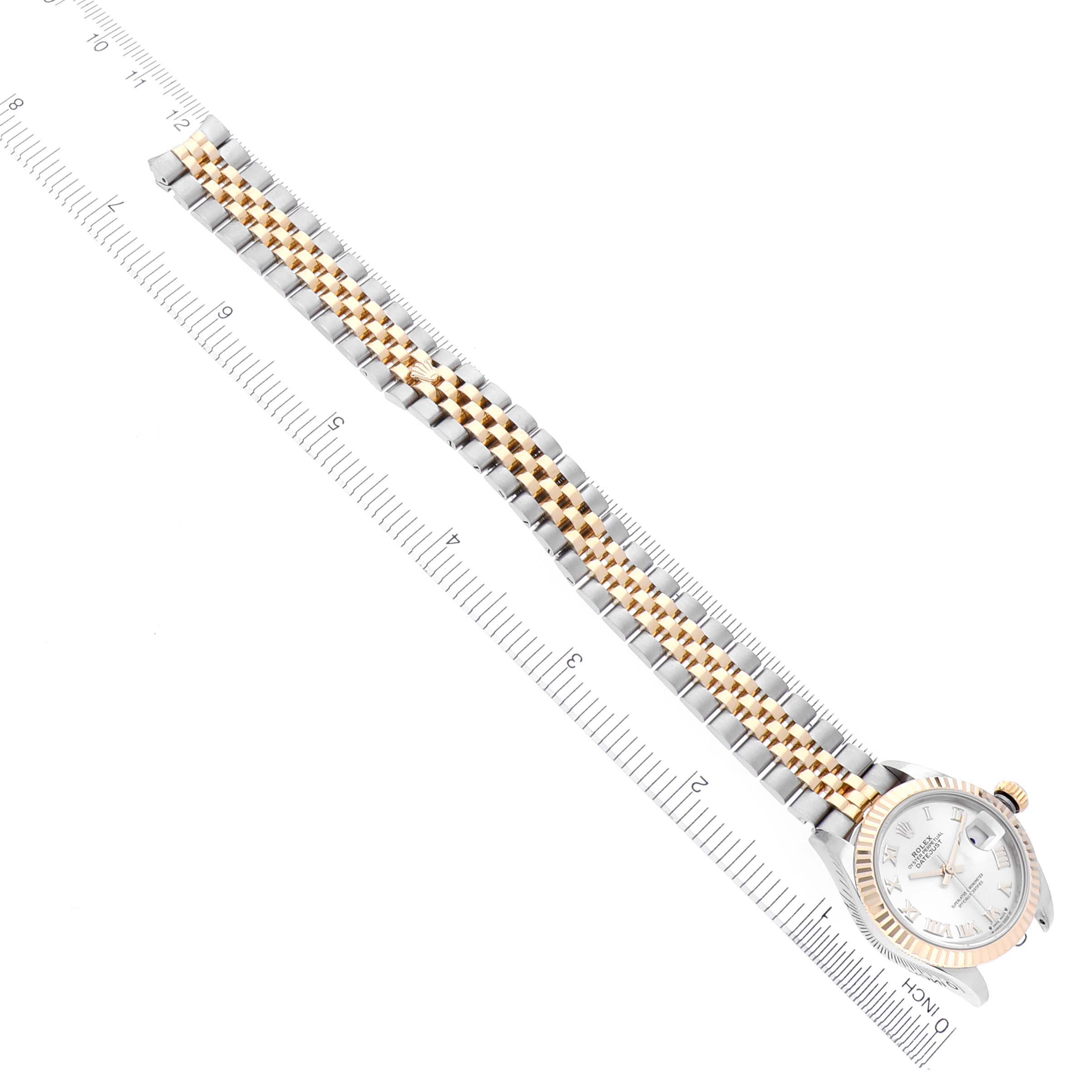 The Rolex Datejust 279173 Women's Steel and Gold (two tone) Silver Dial 279173 Women's Steel and Gold (two tone) Silver Dial watch is shown from an angled top view, displaying the face and full bracelet, with a ruler for scale.