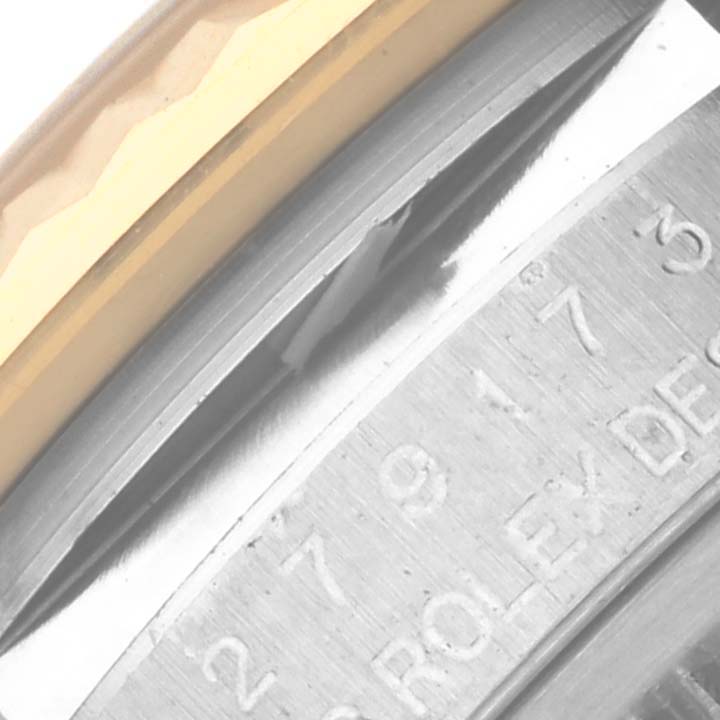 Close-up of the Rolex Datejust 279173 Women's Steel and Gold (two tone) Silver Dial 279173 Women's Steel and Gold (two tone) Silver Dial's bezel edge and engraved serial details on the inner ring.