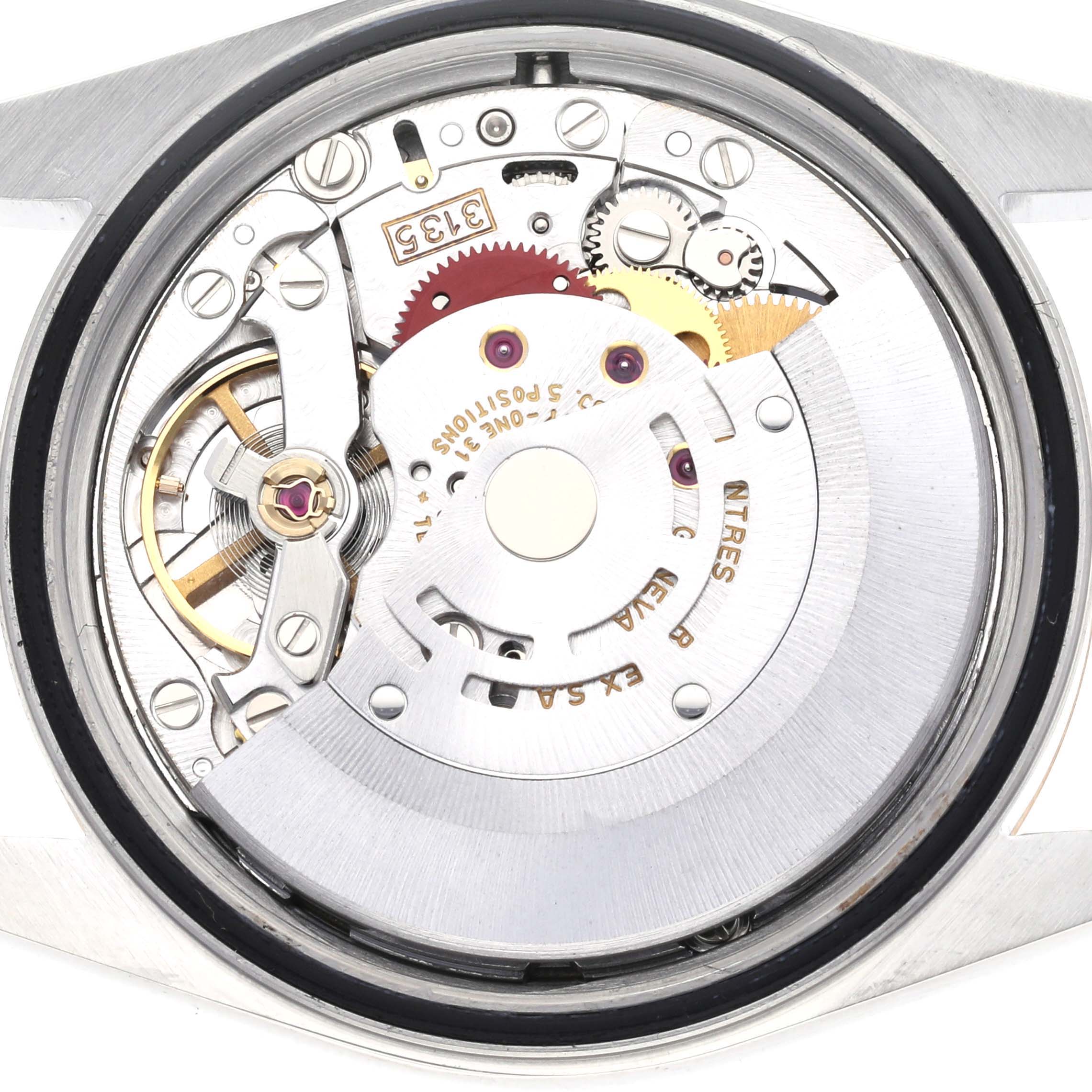 The image shows a close-up of the movement mechanism of a Rolex Datejust 16233 Men
s Steel and Gold (two tone) Champagne Dial 16233 Men
s Steel and Gold (two tone) Champagne Dial watch from the back angle.
