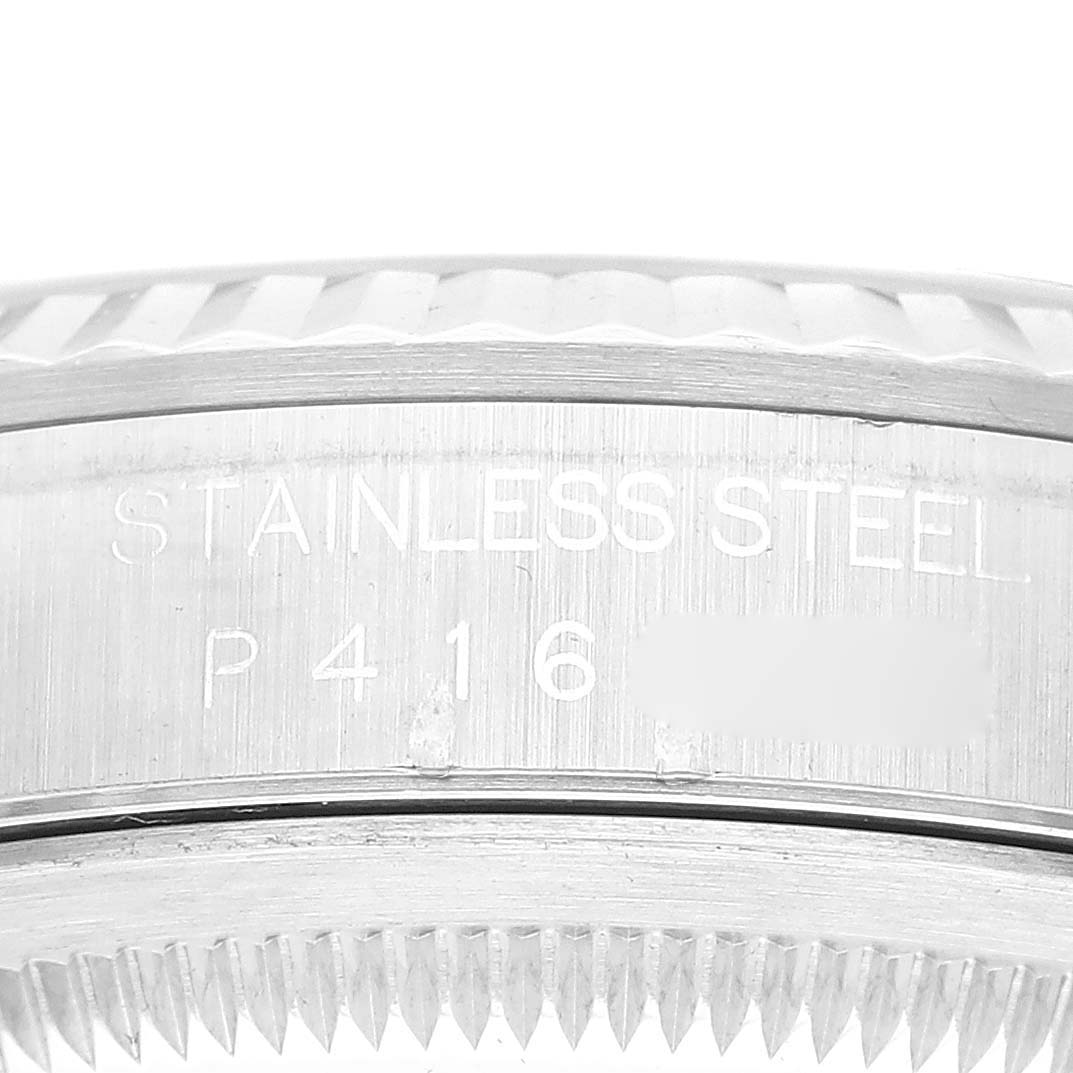 This image shows an angled close-up of the side of a stainless steel Rolex Datejust 16234 Men's Stainless Steel Blue Dial 16234 Men's Stainless Steel Blue Dial watch case with visible engravings.