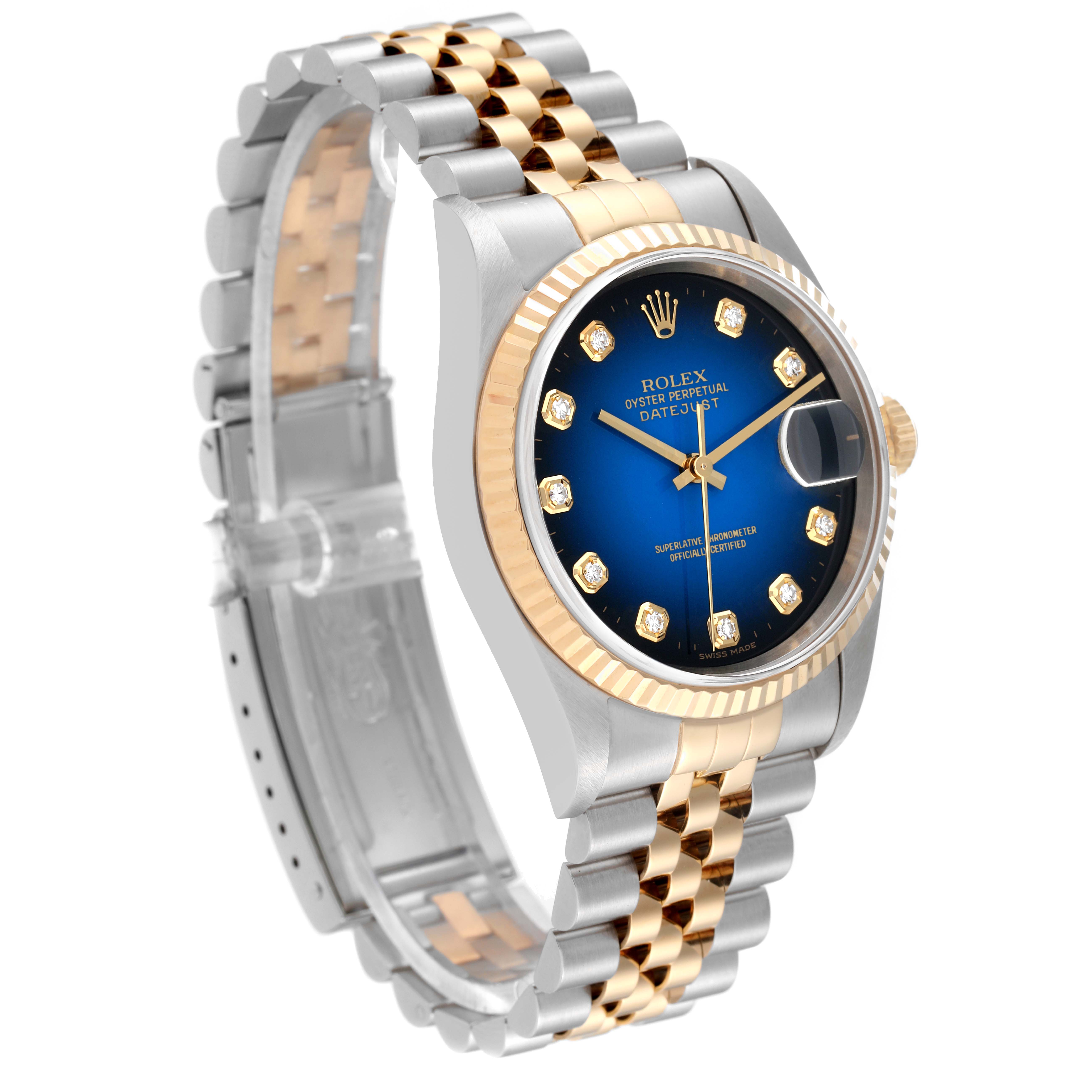 This Rolex Datejust 16233G Men's Steel and Gold (two tone) Blue Dial 16233G Men's Steel and Gold (two tone) Blue Dial watch is shown from a front-left angle, displaying its face, bezel, and bracelet.