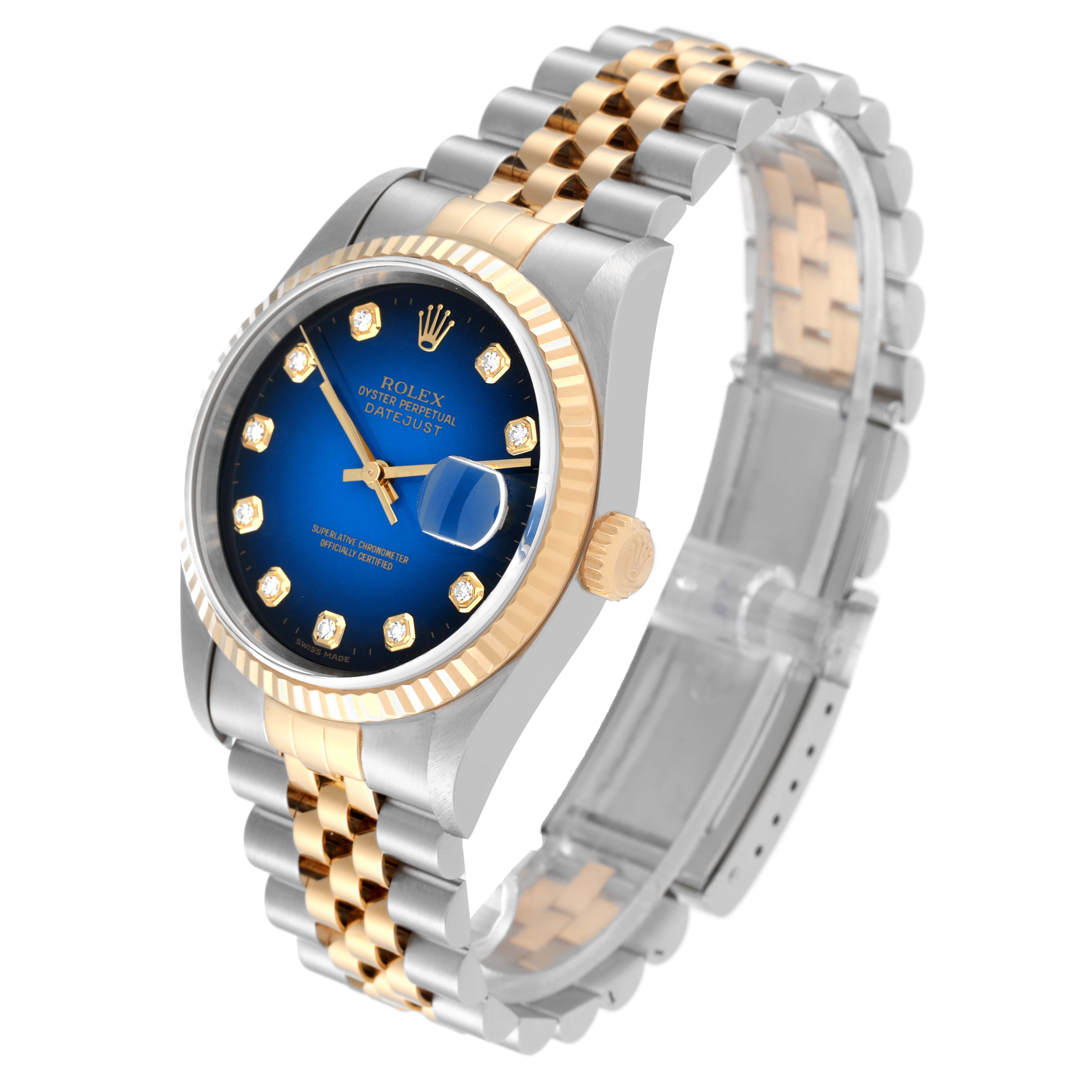 This image shows a Rolex Datejust 16233G Men's Steel and Gold (two tone) Blue Dial 16233G Men's Steel and Gold (two tone) Blue Dial model watch at a slight tilted angle, highlighting its blue dial, fluted bezel, and two-tone bracelet.