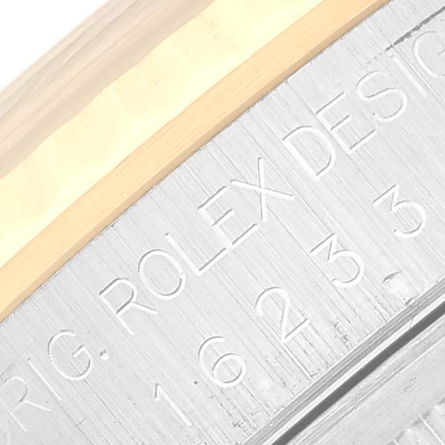 This image shows a macro shot of the model number and part of the bezel of a Rolex Datejust 16233G Men's Steel and Gold (two tone) Blue Dial 16233G Men's Steel and Gold (two tone) Blue Dial watch.