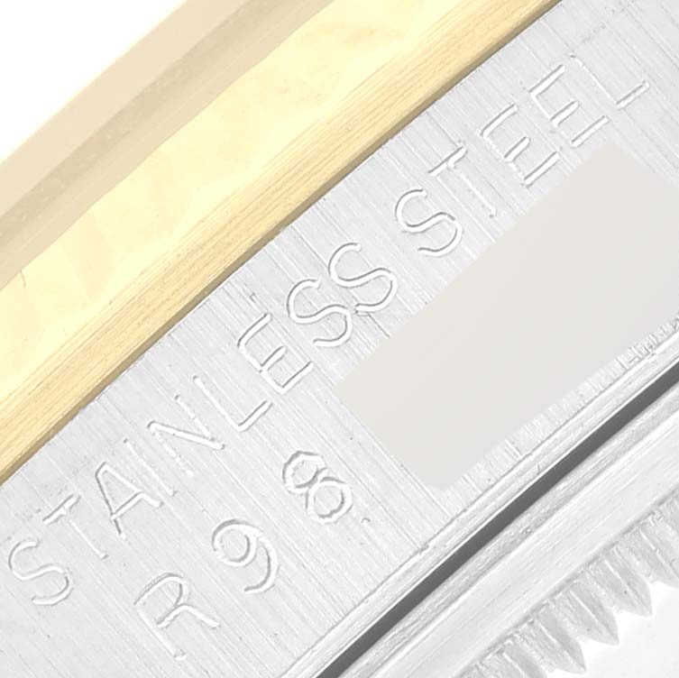 This close-up image shows the bezel and part of the case with "STAINLESS STEEL" engraving of the Rolex Datejust 16233 Men's Steel and Gold (two tone) Champagne Dial 16233 Men's Steel and Gold (two tone) Champagne Dial model.