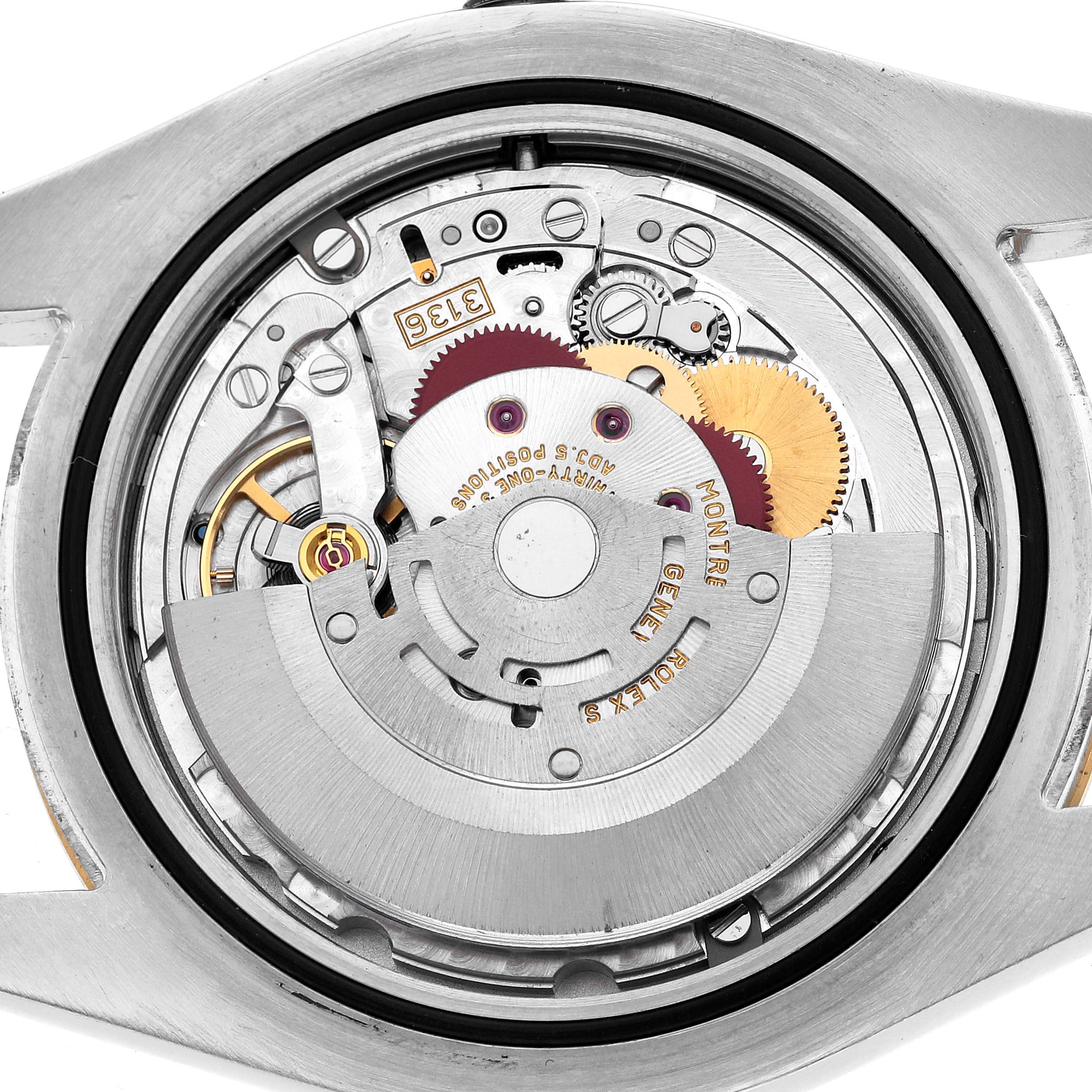 The image shows the movement mechanism of a Rolex Datejust 41 116333 Men's Steel and Gold (two tone) Champagne Dial, viewed from the back with visible gears and components.