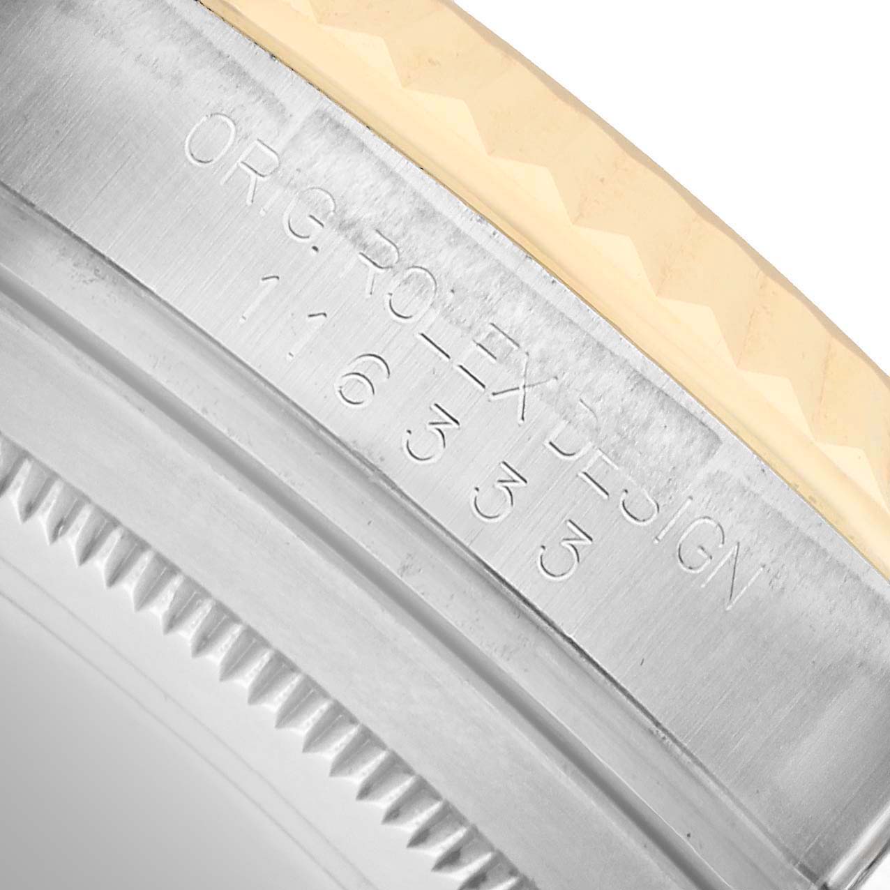 The image shows a close-up of the Rolex Datejust 41 116333 Men's Steel and Gold (two tone) Champagne Dial bezel, highlighting the detailed engraving and metal texture.