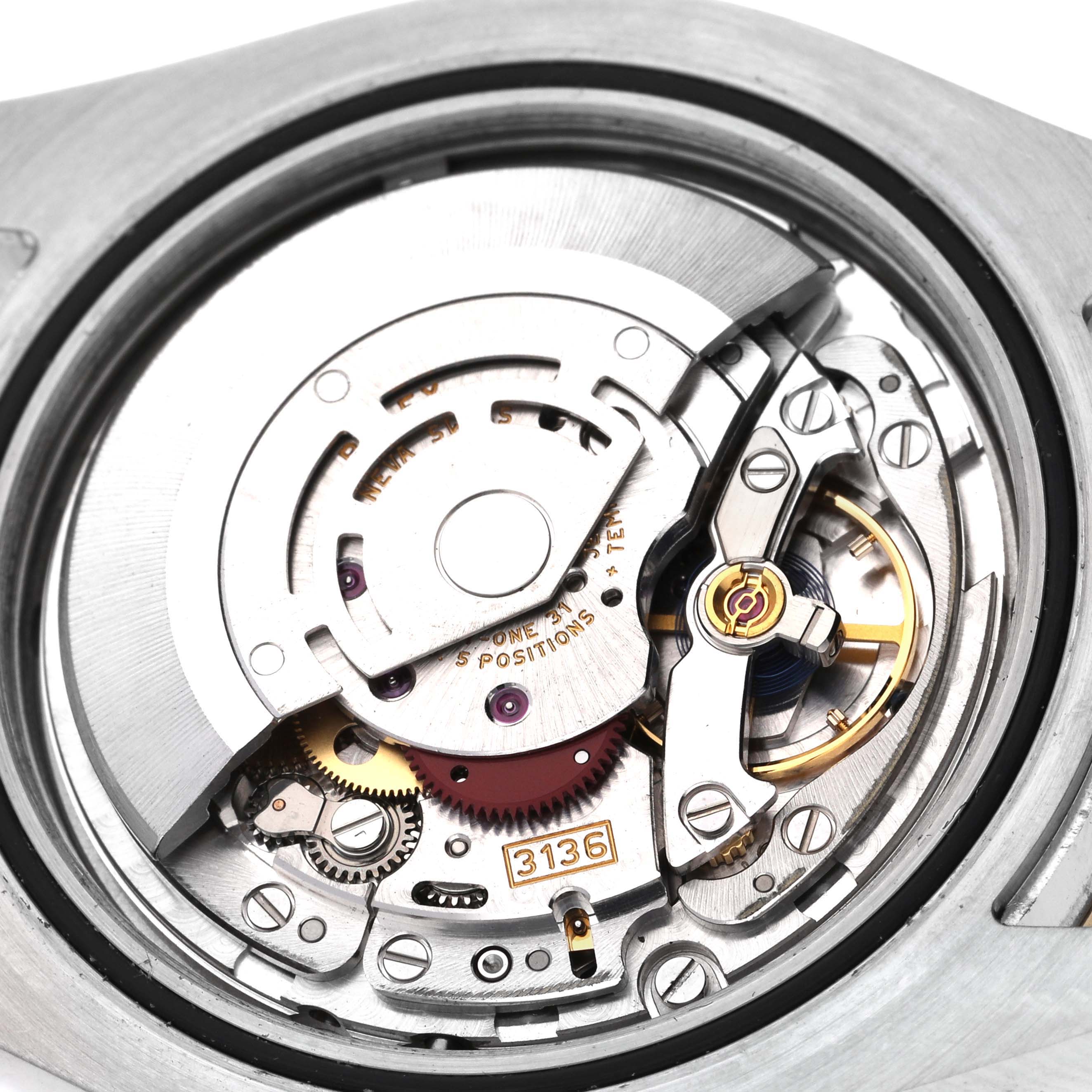 The image shows the intricate movement mechanism of a Rolex Datejust 41 116333 Men's Steel and Gold (two tone) Grey Dial 116333 Men's Steel and Gold (two tone) Grey Dial watch, including gears and the rotor.