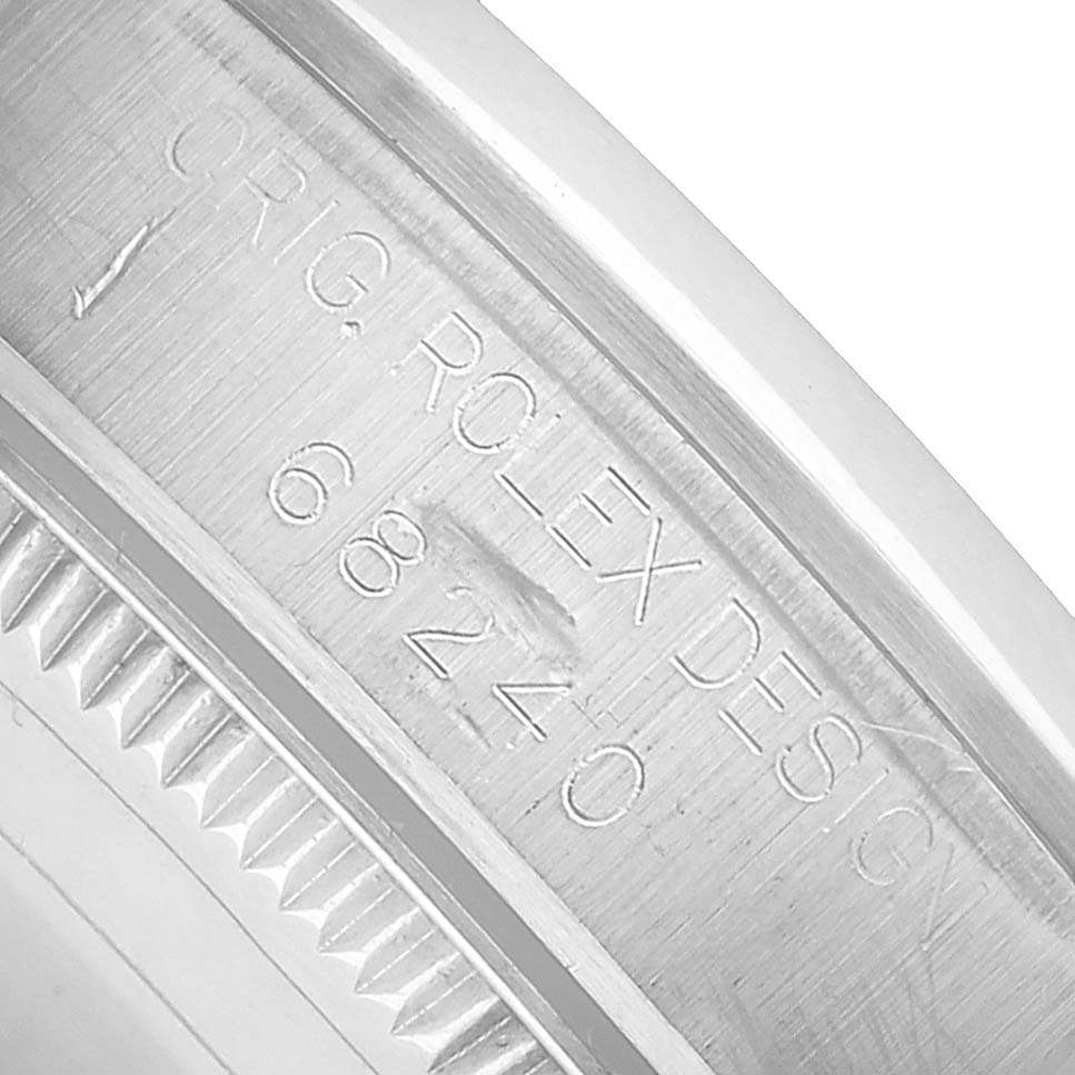 The image shows a close-up of the engraved inner bezel of a Rolex Datejust 68240 Women's Stainless Steel Pink Dial watch.