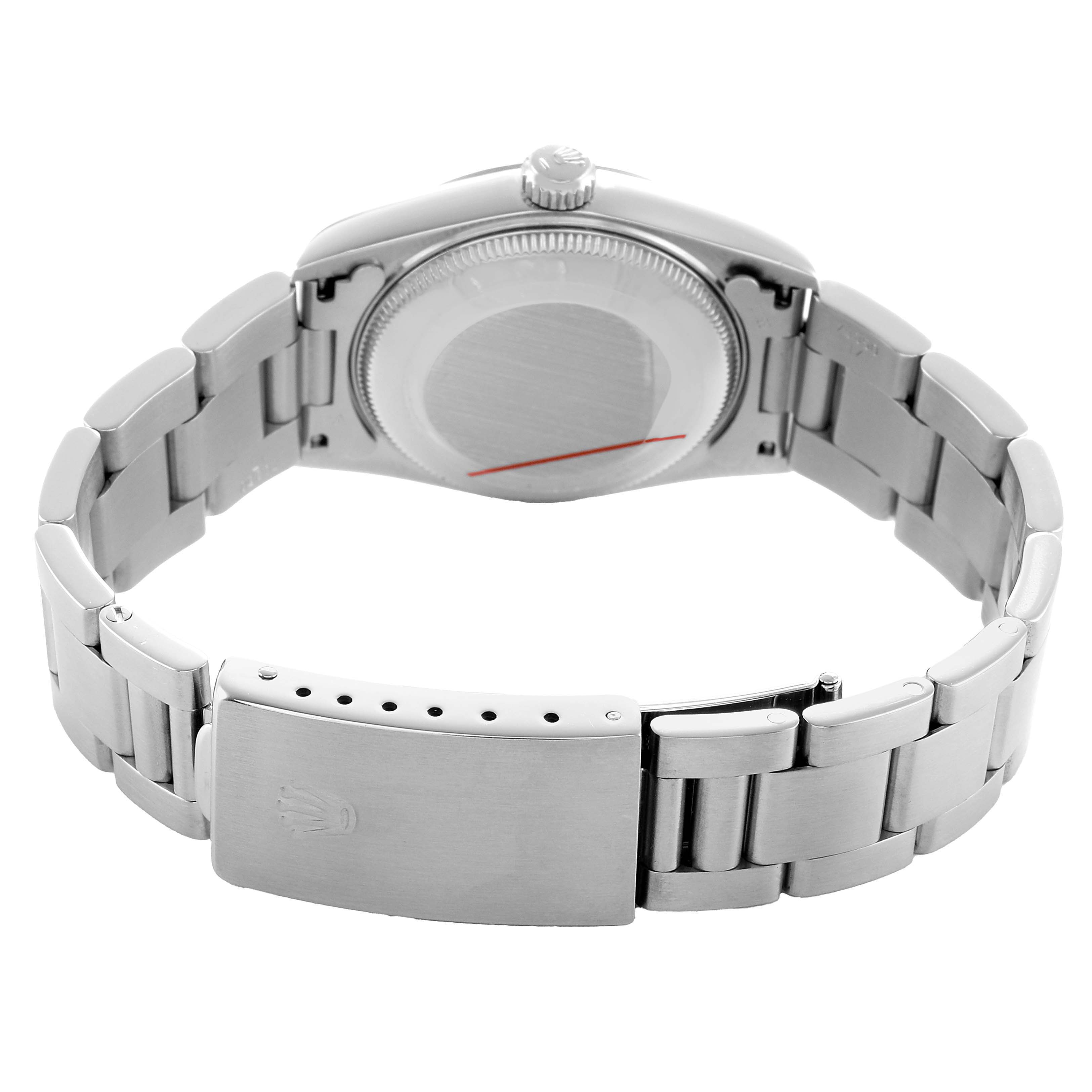 The Rolex Datejust 68240 Women's Stainless Steel Pink Dial watch is shown from the back, displaying the closed clasp and the case back with the bracelet partially extended.