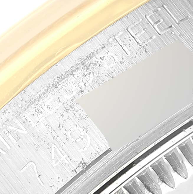 The image shows a close-up angle of the serial number engraving on a Rolex Mid-Size 68243 Women
s Steel and Gold (two tone) Champagne Dial 68243 Women
s Steel and Gold (two tone) Champagne Dial watch case.