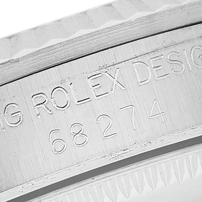 This close-up image shows the engraved serial number and design inscription on the side of a Rolex Mid-Size 68274 Women
s Stainless Steel Silver Dial 68274 Women
s Stainless Steel Silver Dial model.