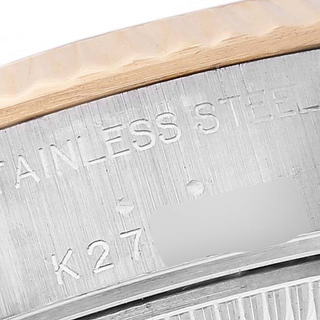 The image shows a close-up of the engraved stainless steel casing and the fluted bezel of a Rolex Datejust 79173 Women's Steel and Gold (two tone) Mother of Pearl Dial 79173 Women's Steel and Gold (two tone) Mother of Pearl Dial watch.